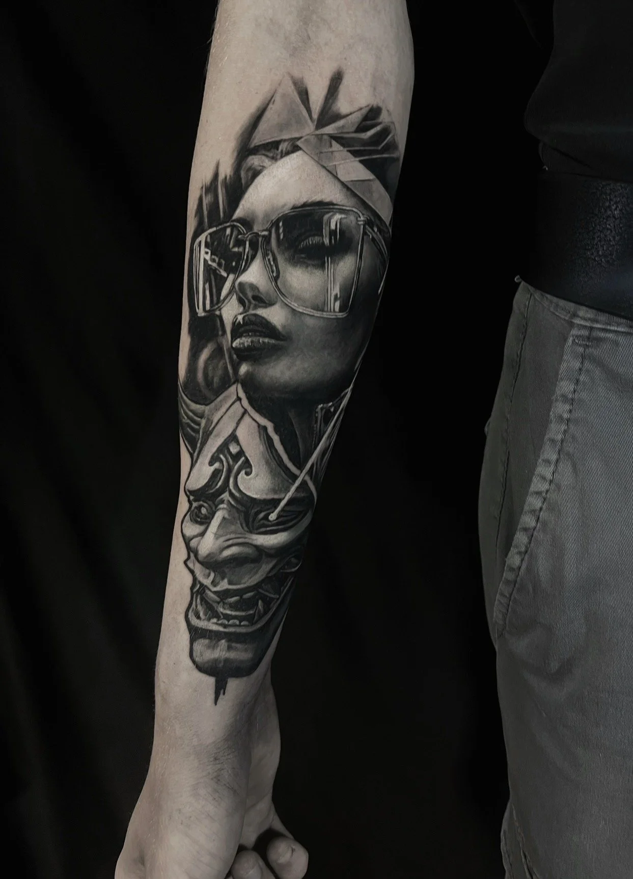 Black and grey portrait tattoo on arm
