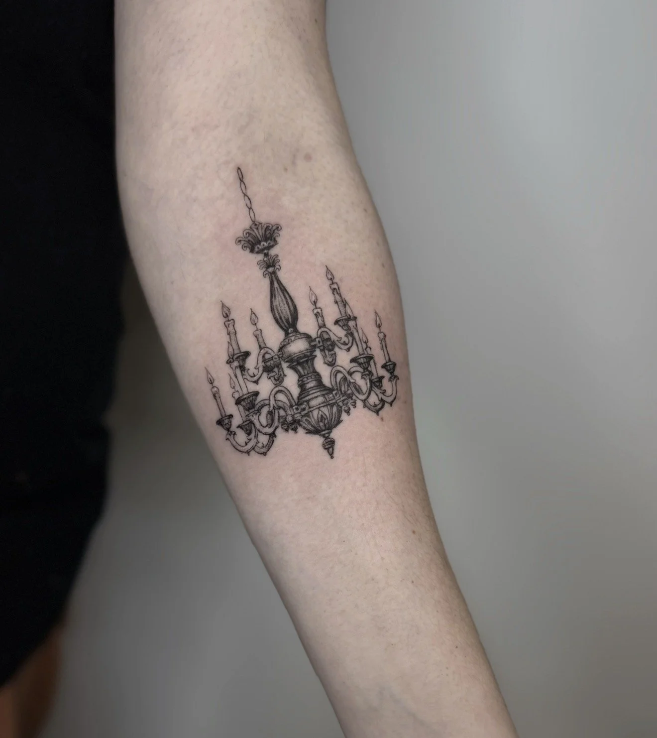 fine line chandelier tattoo on arm