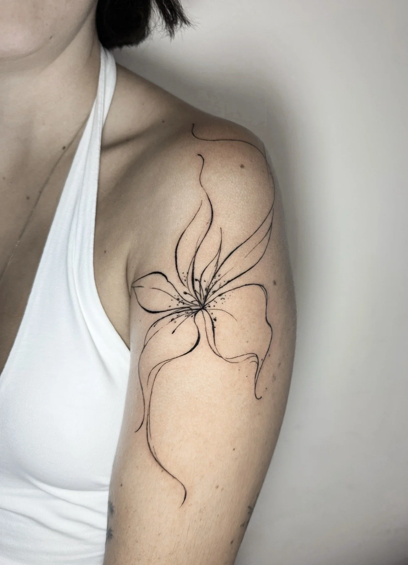 fine line flower tattoo