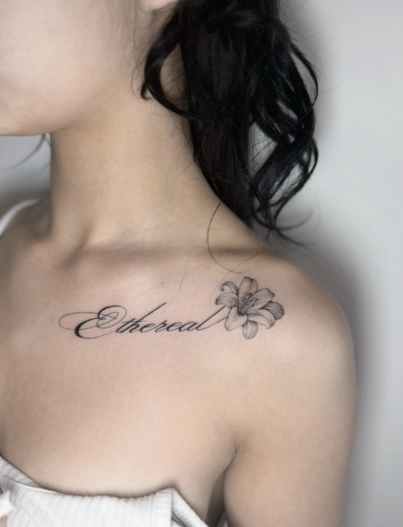 collarbone script tattoo