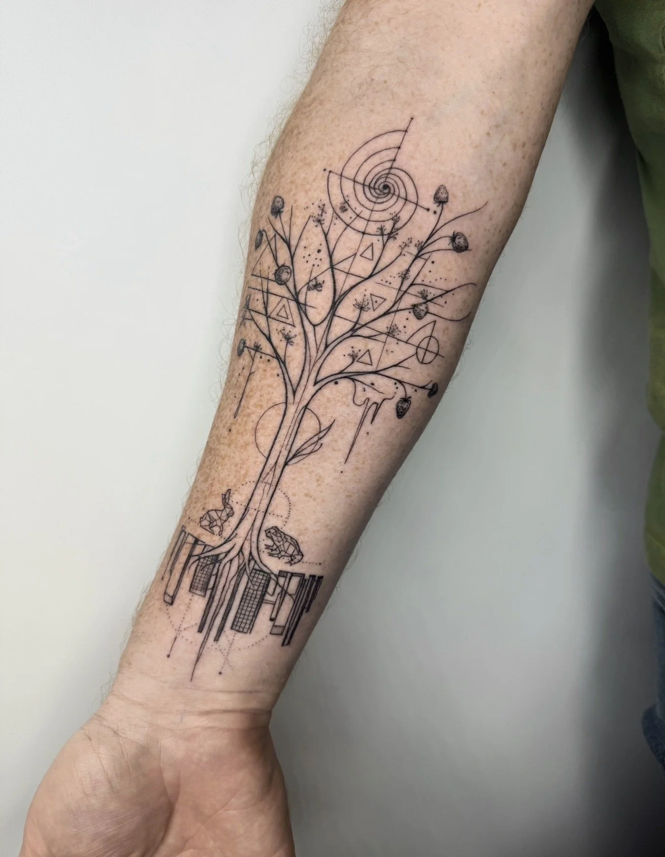 Fine line abstract tree tattoo on forearm