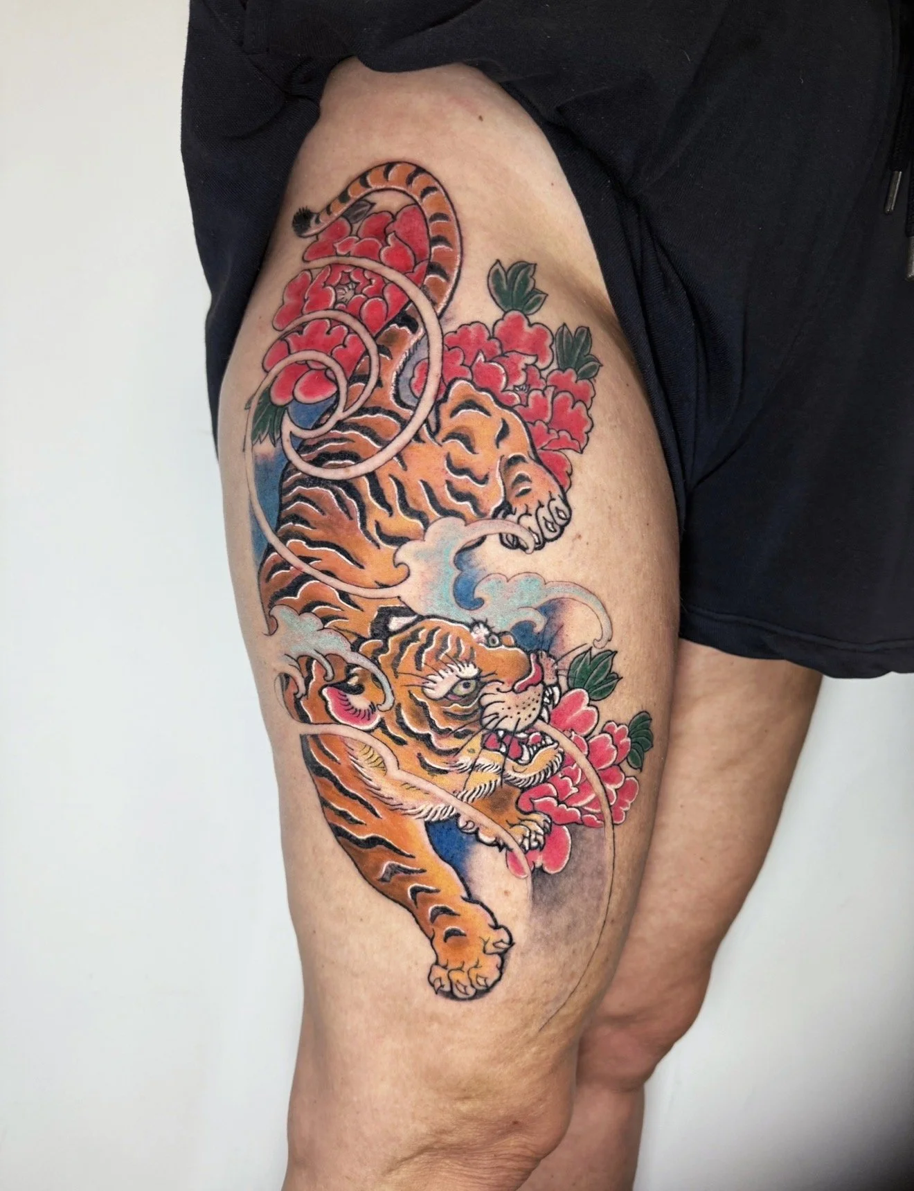 Japanese tiger and peony thigh tattoo