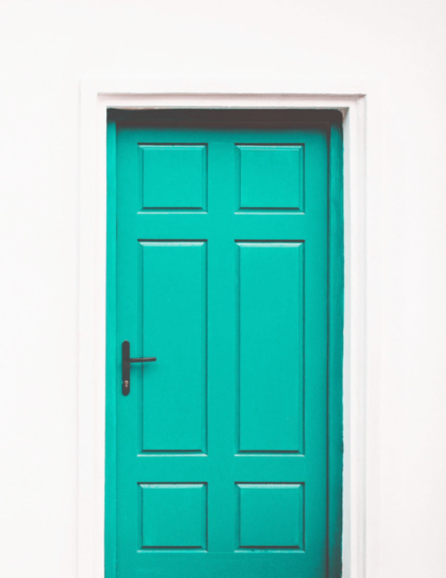 Vibrant teal closed door framed by a white wall, symbolizing opportunity, exclusivity, and the potential unlocked by working with Brit Sells The City.