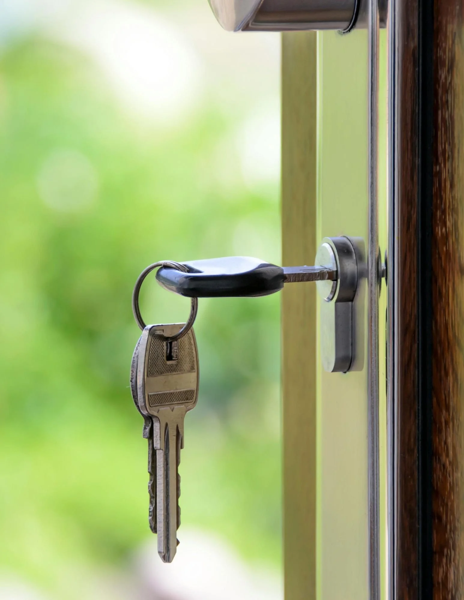 A luxury home key turns in an elegant wooden door, symbolizing success, security, and homeownership in Hampton Roads.