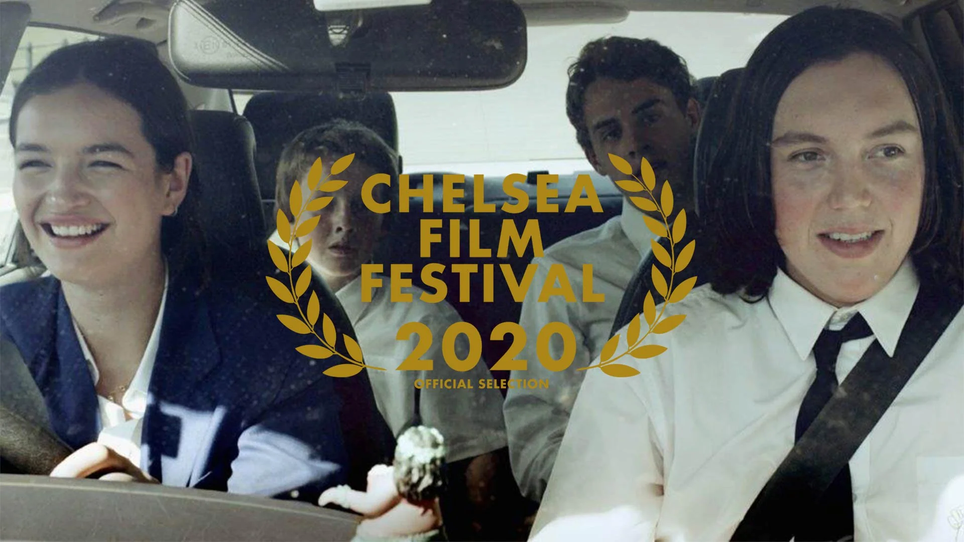 A still from the film 'The Yiddish Key' showing four characters inside a car, with a woman in the front passenger seat, three children in the back seats, and a gold laurel wreath overlaying the image with the text 'Chelsea Film Festival 2020 Official Selection'.