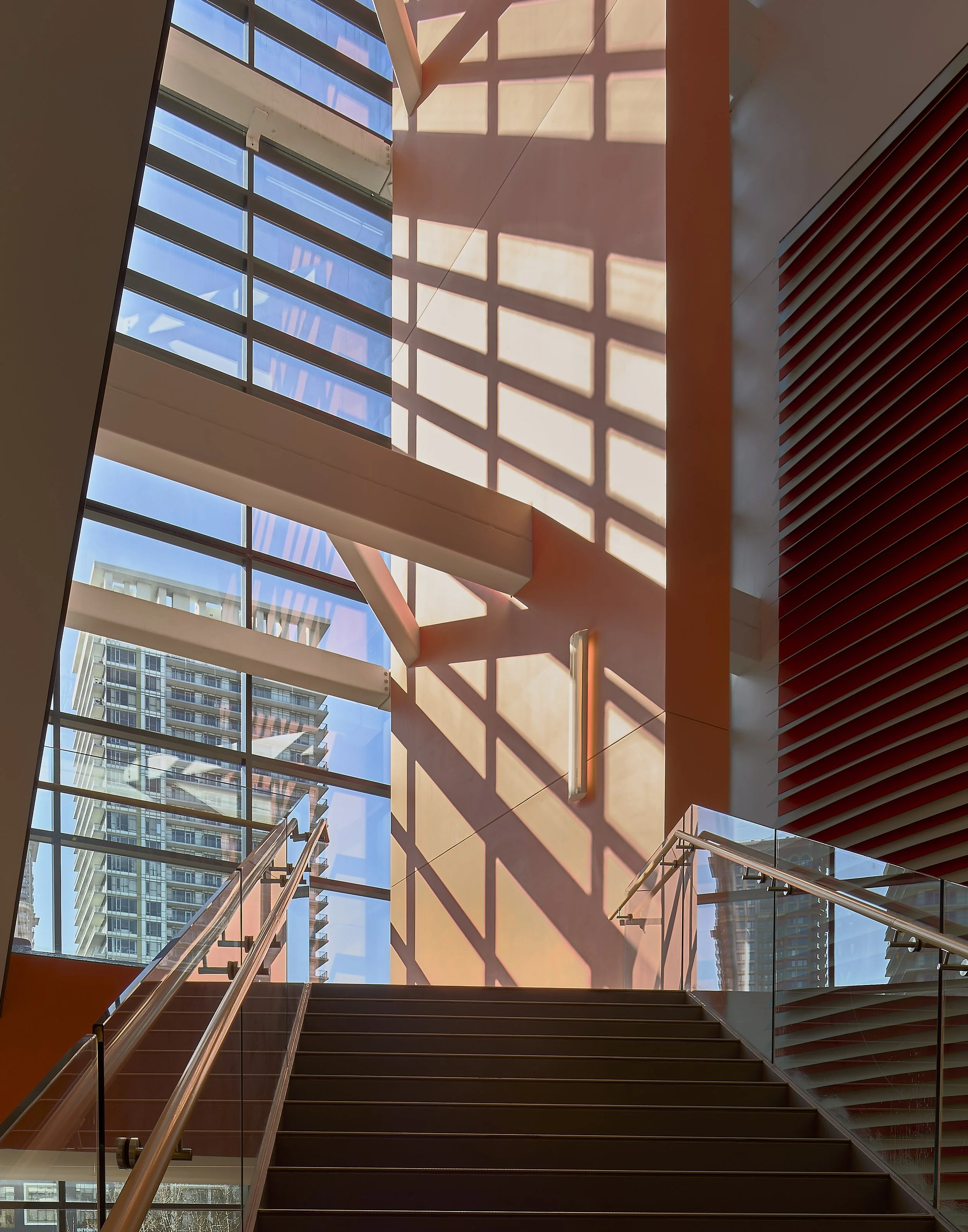 Warm orange-lit architectural stairwell photographed by Obscura Dreams