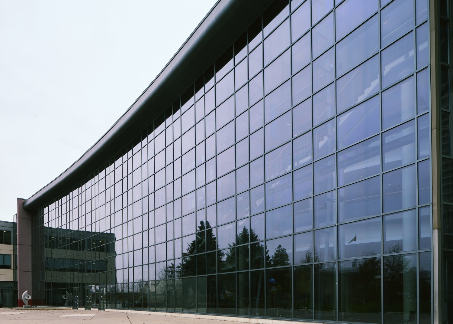 Geometric glass building facade photographed by Obscura Dreams