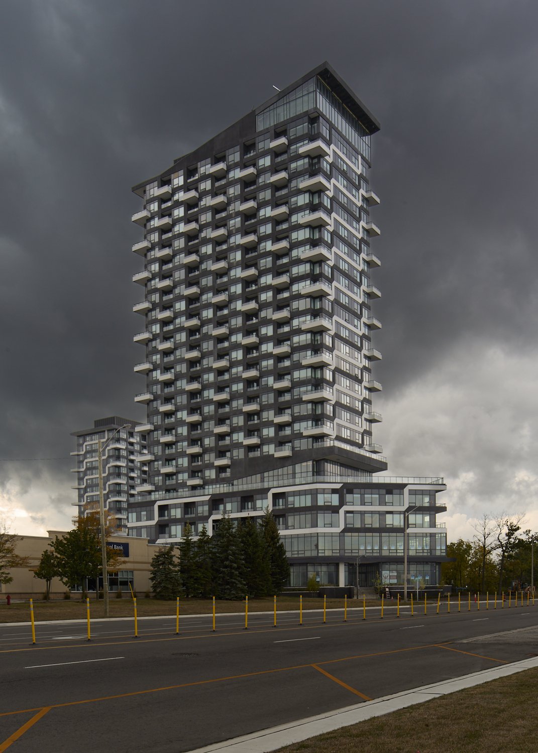 Building beneath dramatic storm clouds photographed by Obscura Dreams