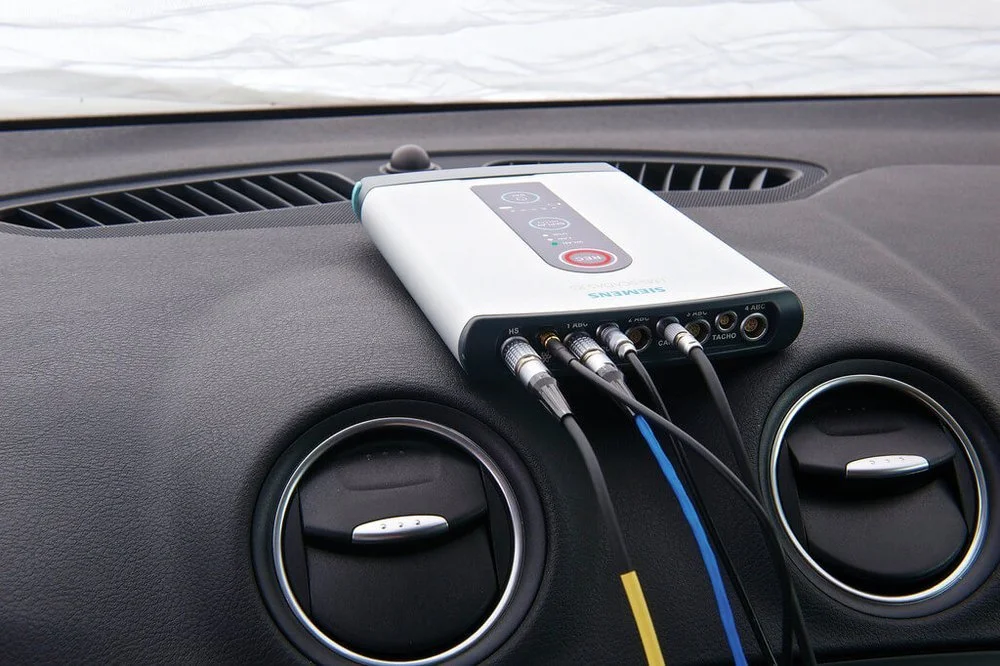 Siemens device with cables on car dashboard