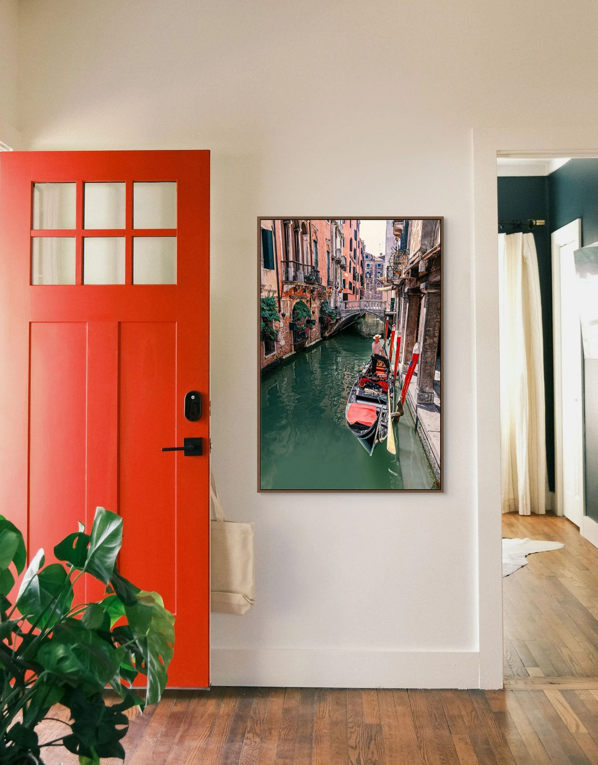 Gondolier navigating a narrow canal in Venice surrounded by historic buildings.