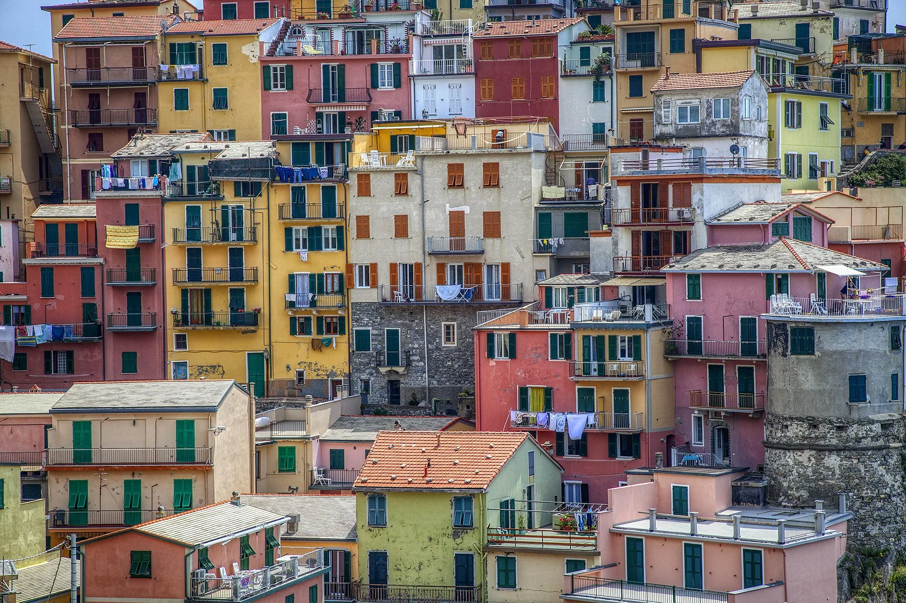 Colourful houses stacked on a hillside in Cinque Terre Italy.