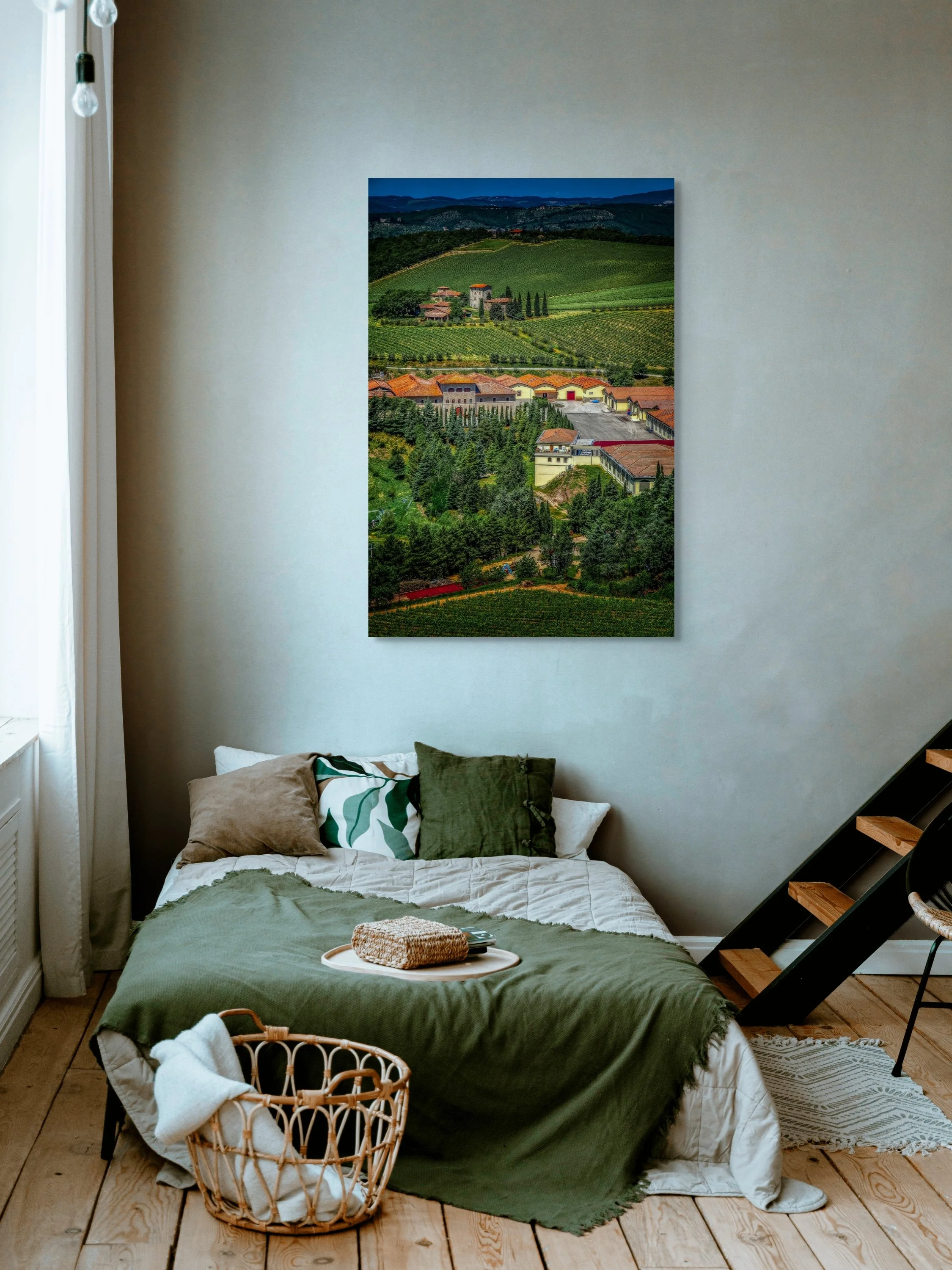 Rolling vineyards and terracotta-roofed buildings in the hills of Tuscany.