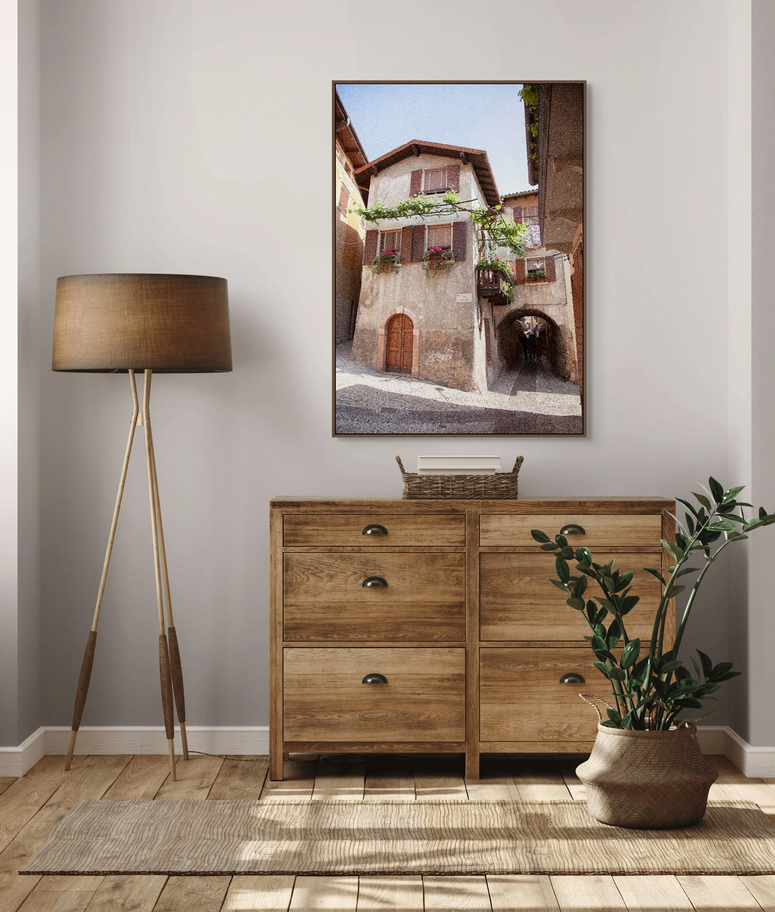 Historic European village street with rustic stone buildings, shutters and archway passage.