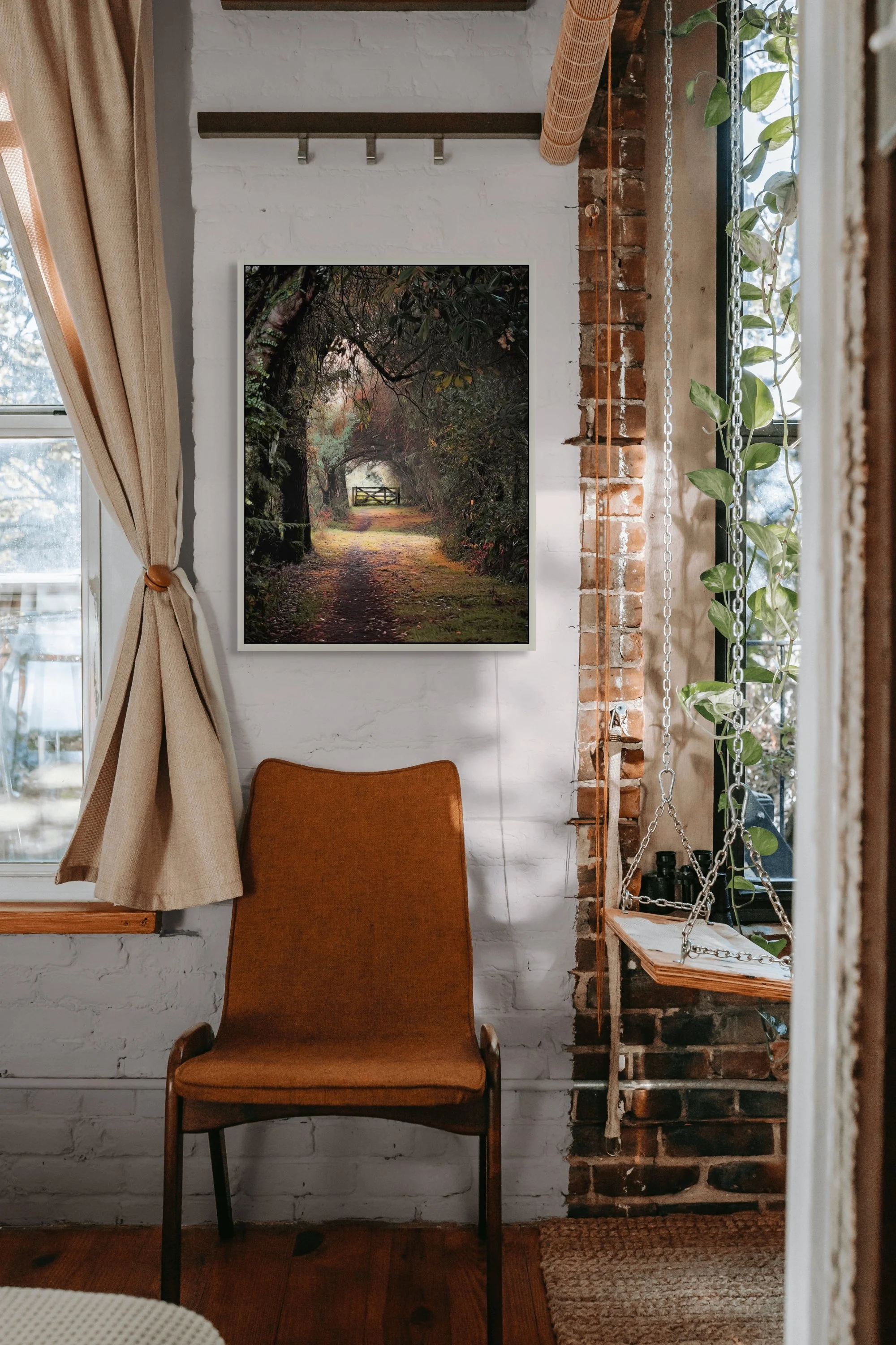 Woodland path leading through trees to a gate in a magical forest setting.