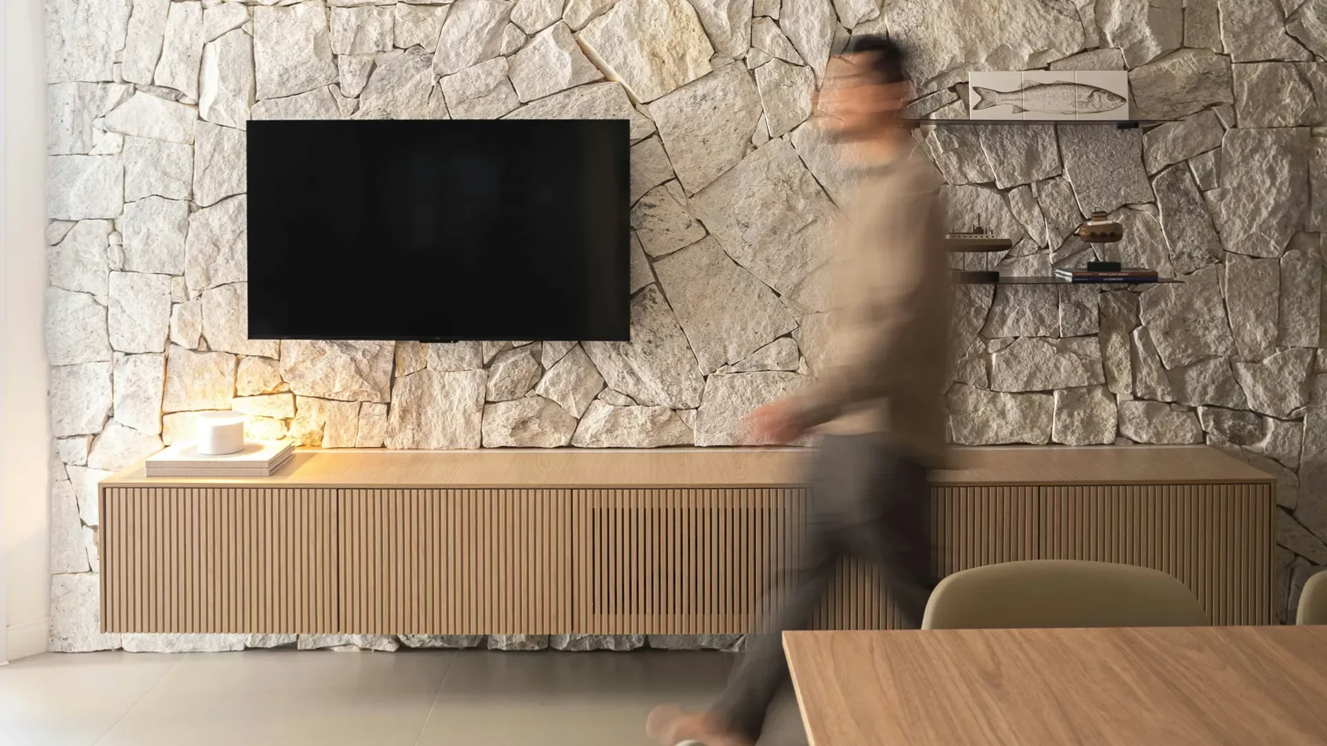 Living room with natural stone and wood elements demonstrating bespoke spatial planning and everyday living