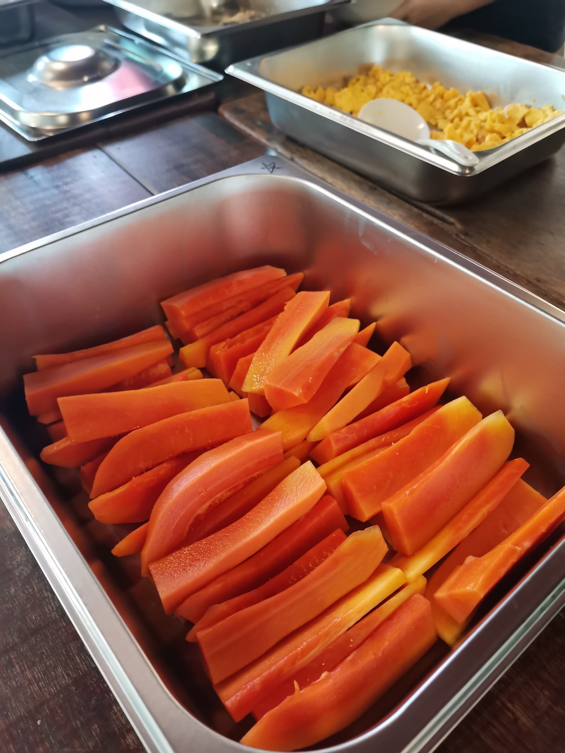 Slices of orange sweet potato arranged in a metal tray.