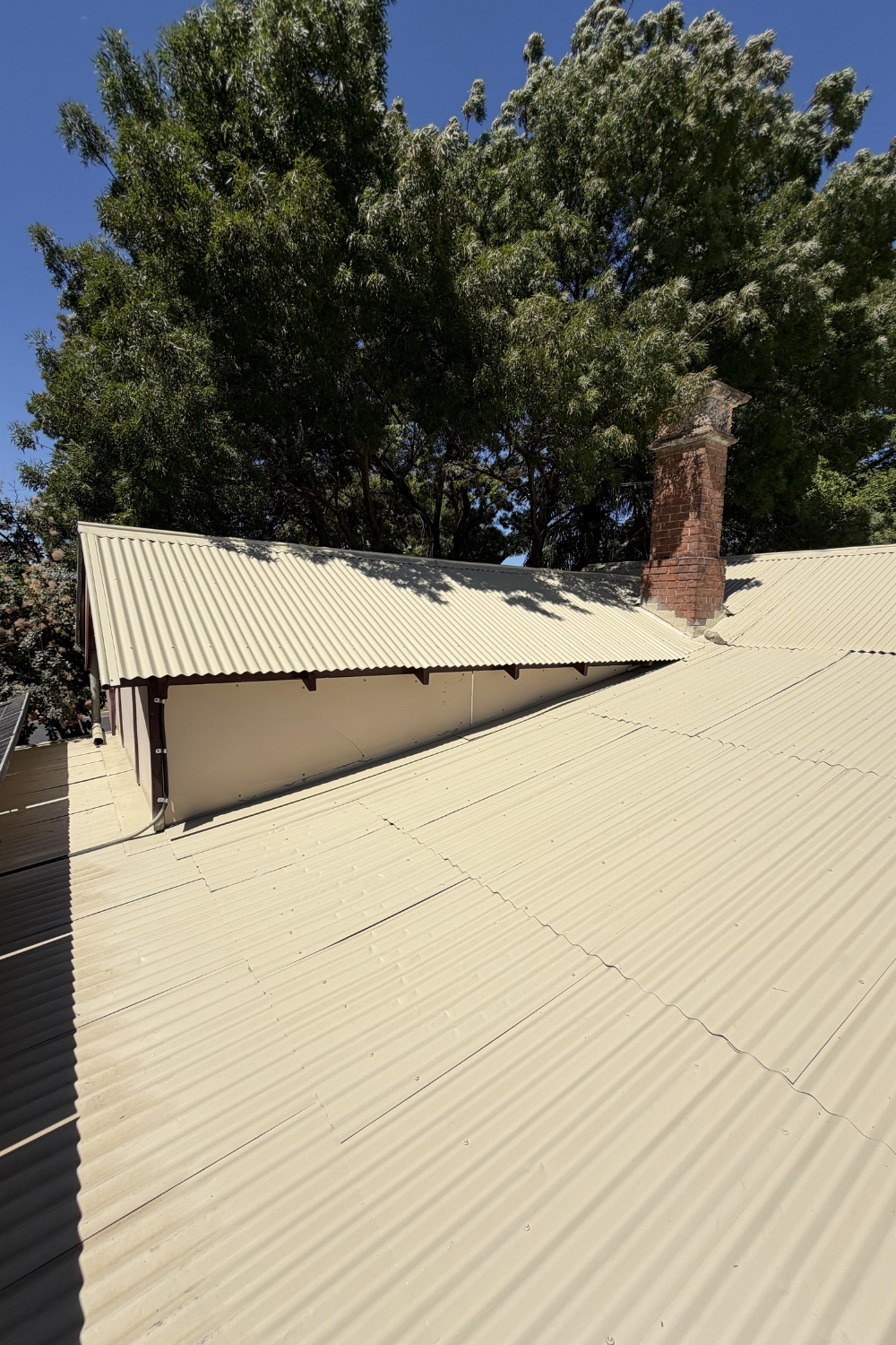 A freshly painted metal roof in Orange Creek after painting cream.