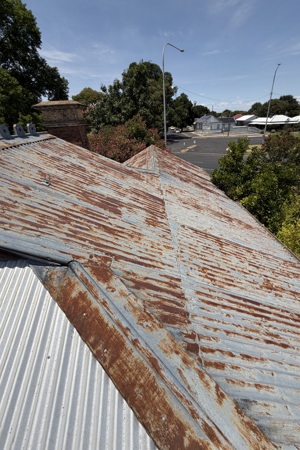 A rusty metal roof in Dixalea prior to painting.