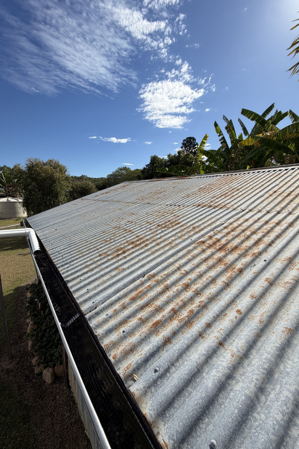 A rusty metal roof in Capella, Queensland prior to painting.