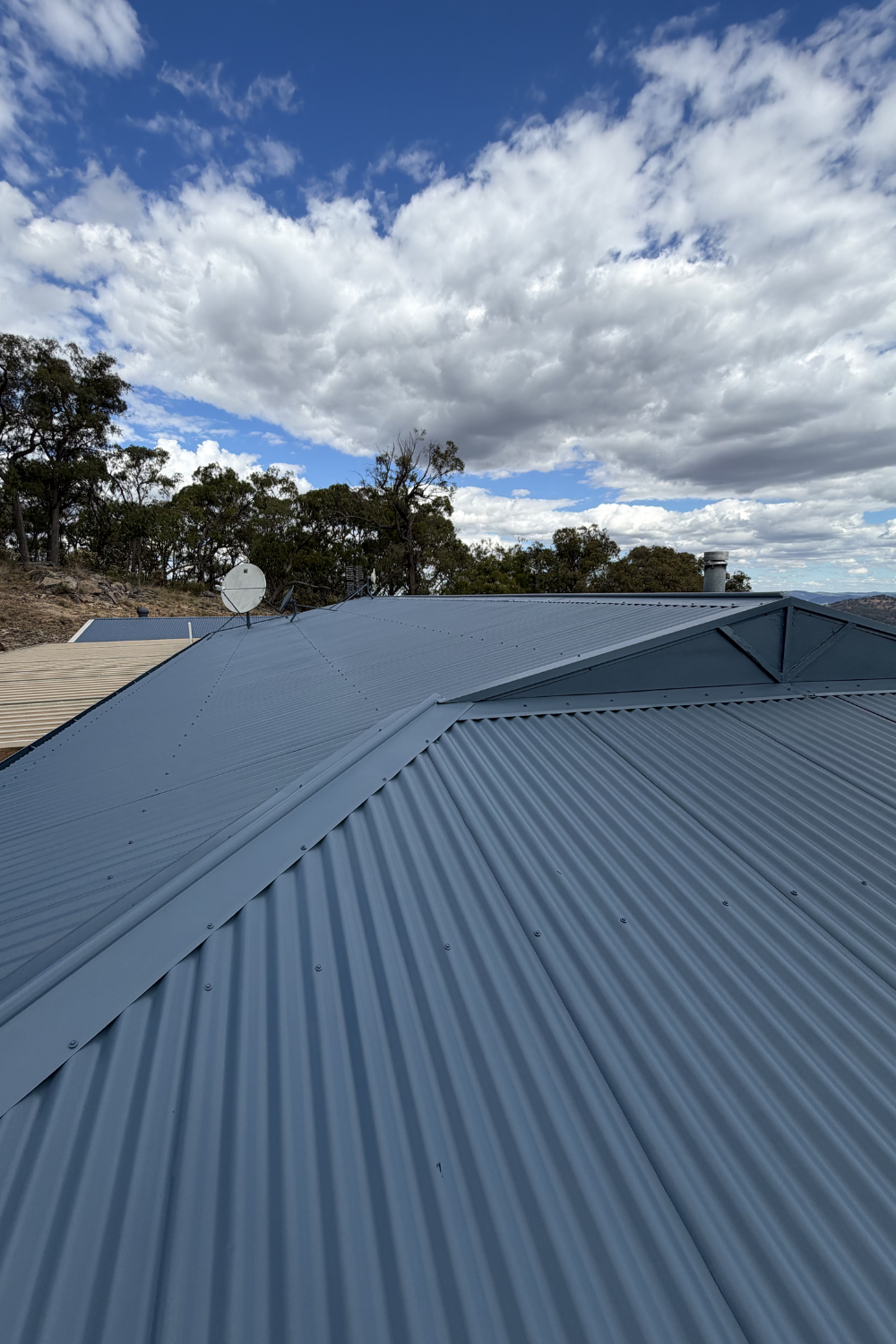 A freshly painted metal roof in St George after painting blue.