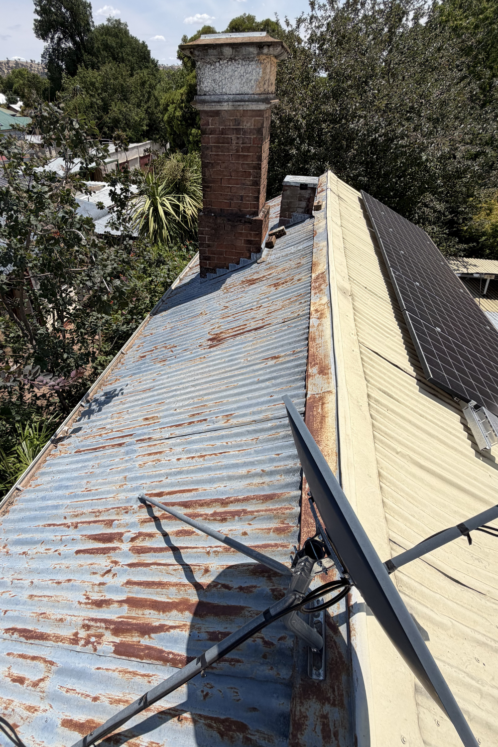 Metal roof near Arcadia Valley before it is painted showing rust and wear.