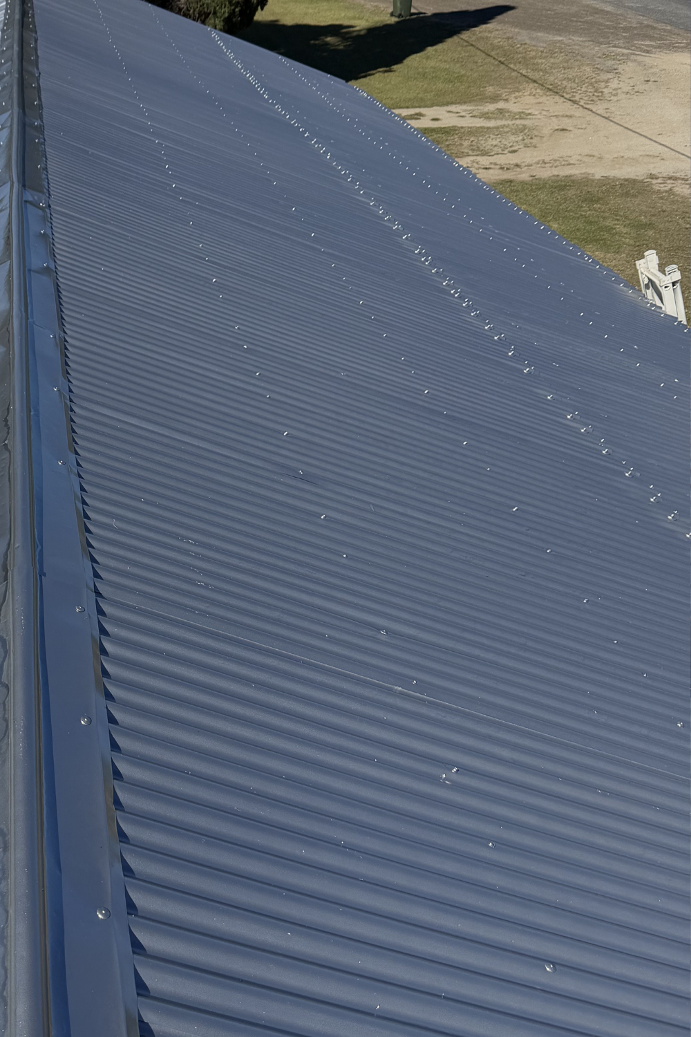 A freshly painted metal roof in Comet after painting grey.