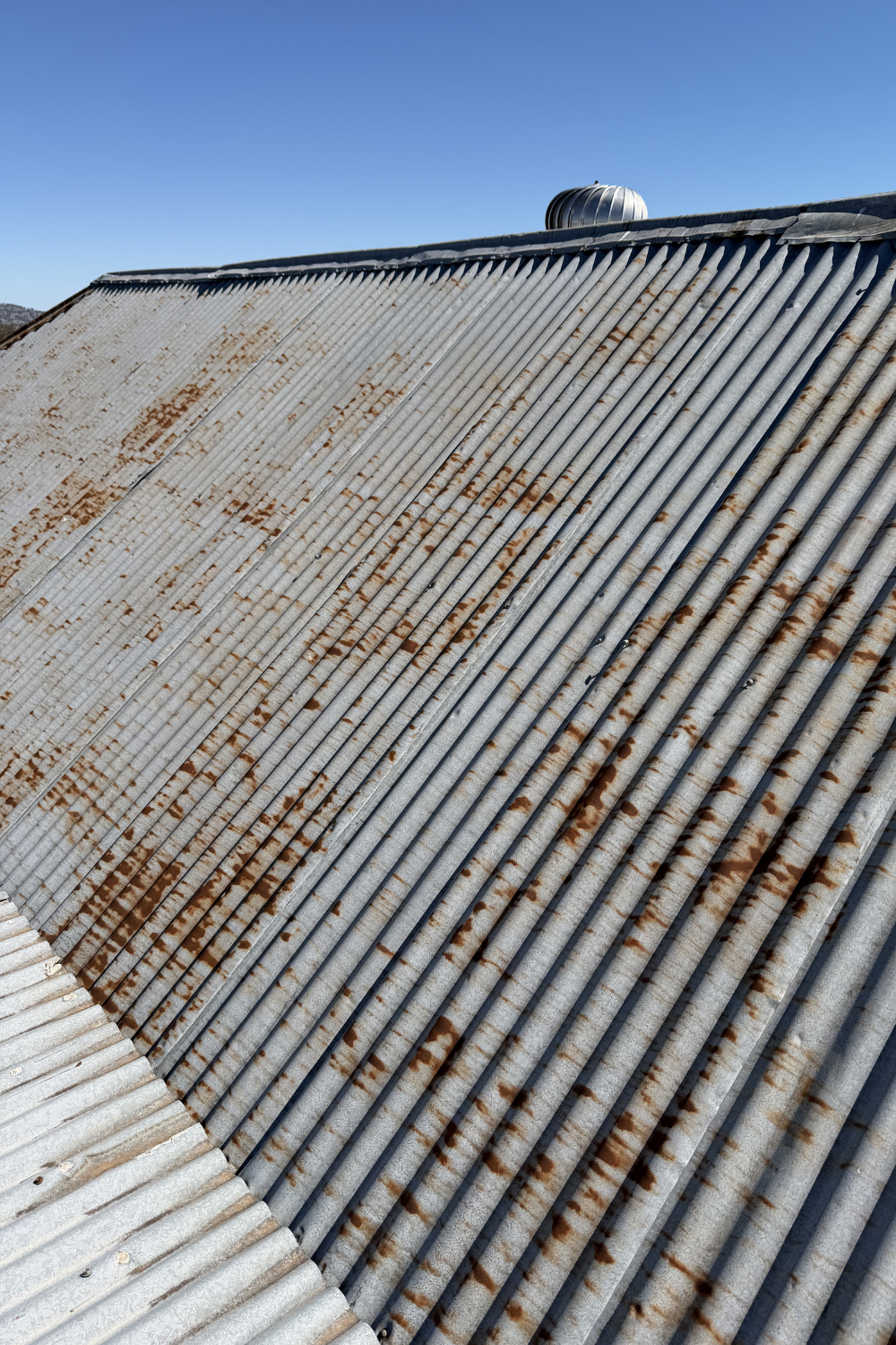 A rusty metal roof in Mitchell prior to painting.