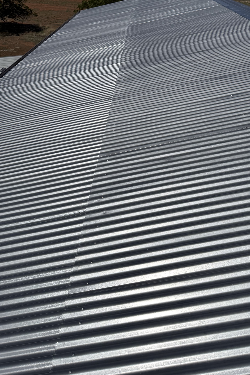 A freshly painted metal roof in Valentines Plains after painting grey.
