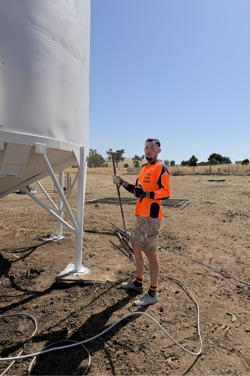 Alfie Hendry with a sprayer painter in a field in Dirranbandi.