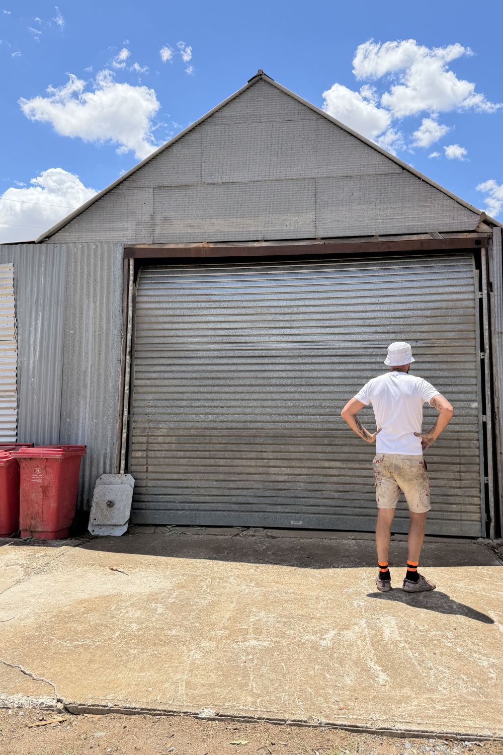 Alfie Hendry of Hendrys Restorations in front of a freshly painted farm shed.
