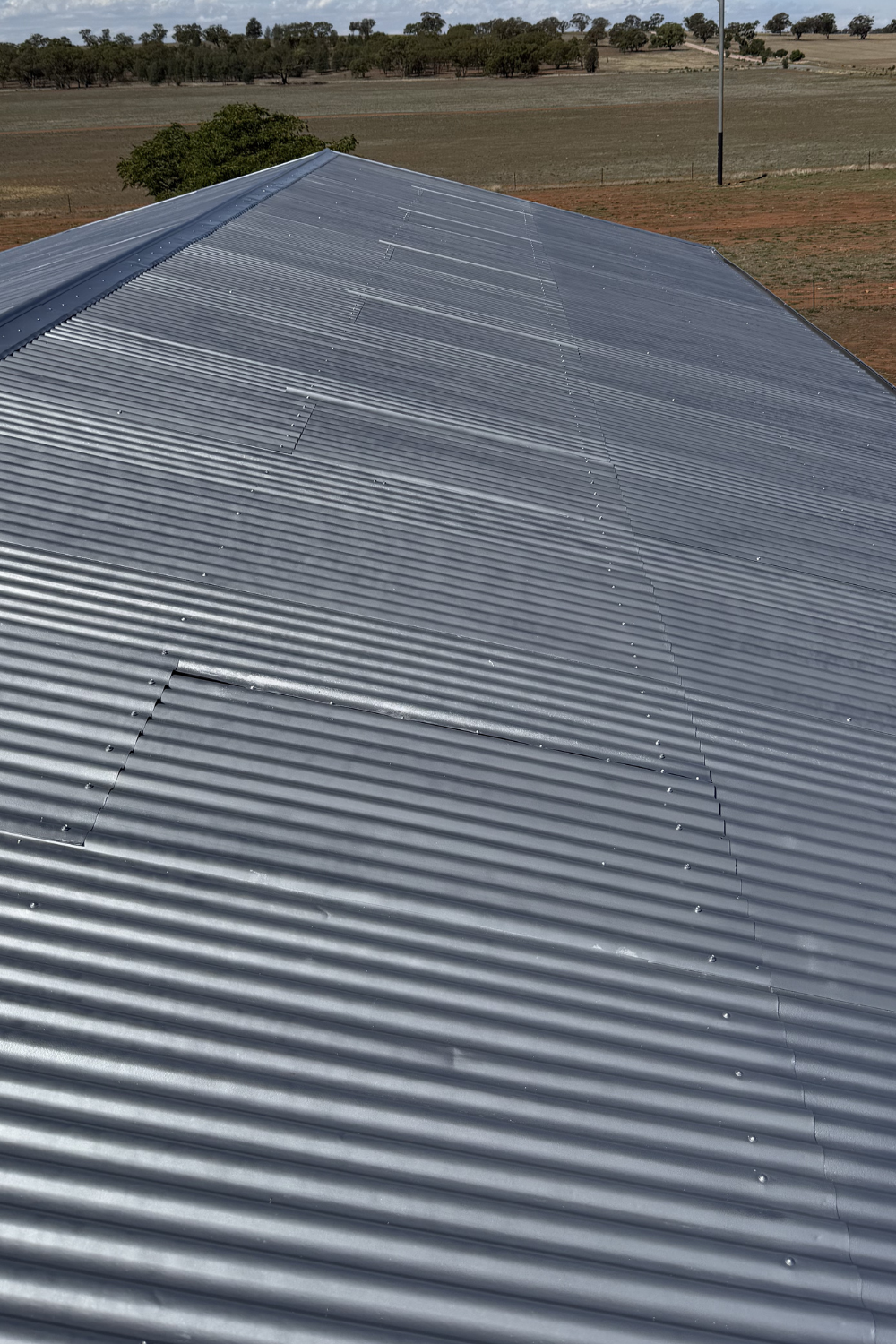 A freshly painted metal roof in Theodore after painting grey.
