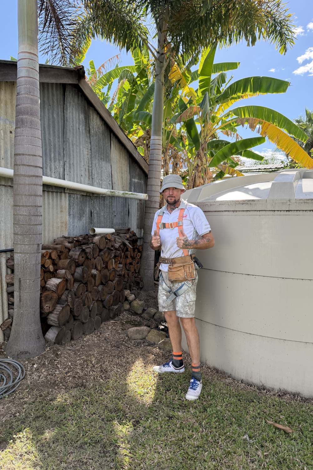 Alfie Hendry a roof painter outside of a shed roof he just painted.
