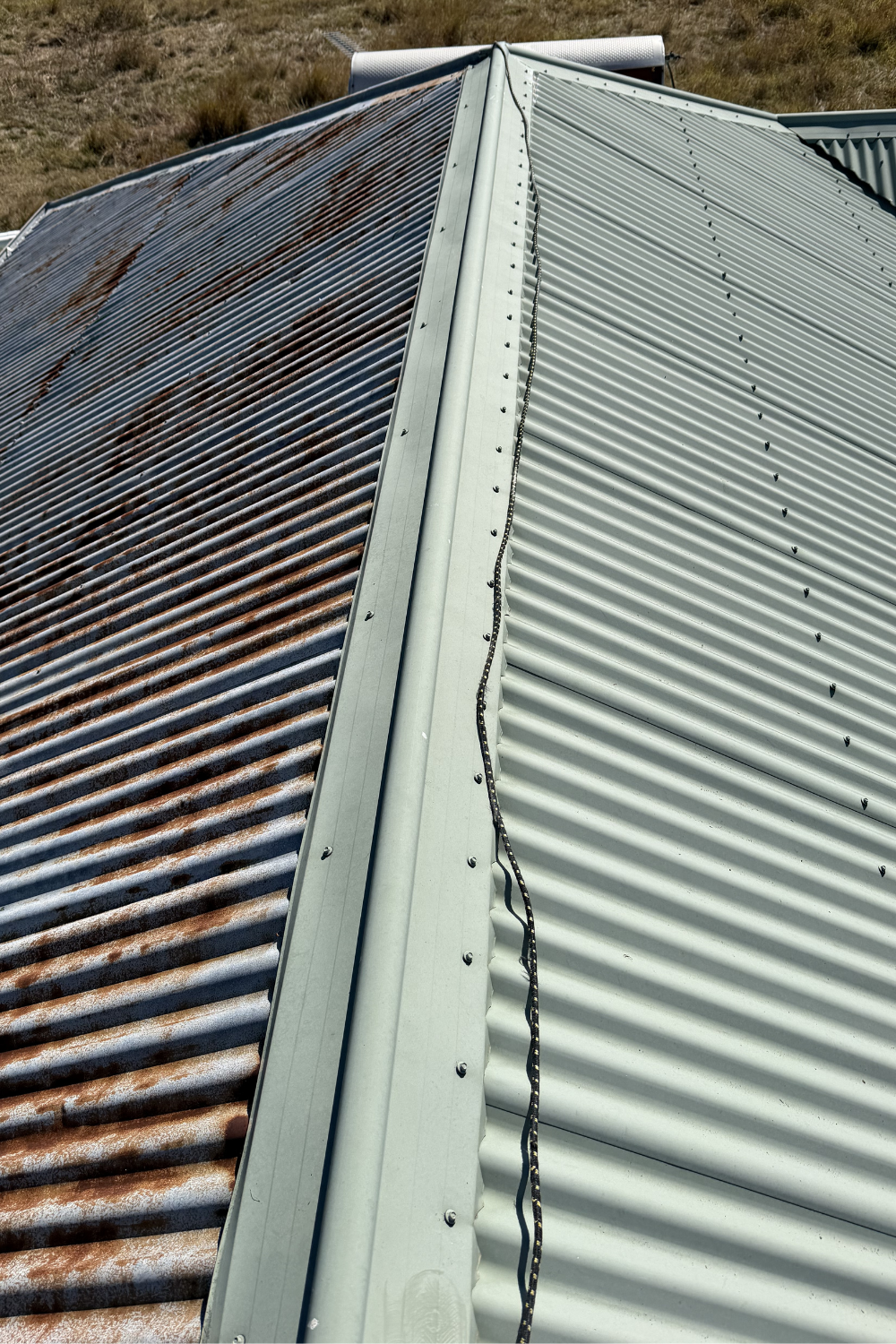 A roof in Rolleston, Queensland, which was rusting and half-painted by another company.