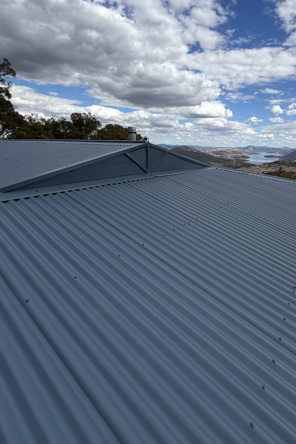 A freshly painted metal roof in Bollon after painting blue.