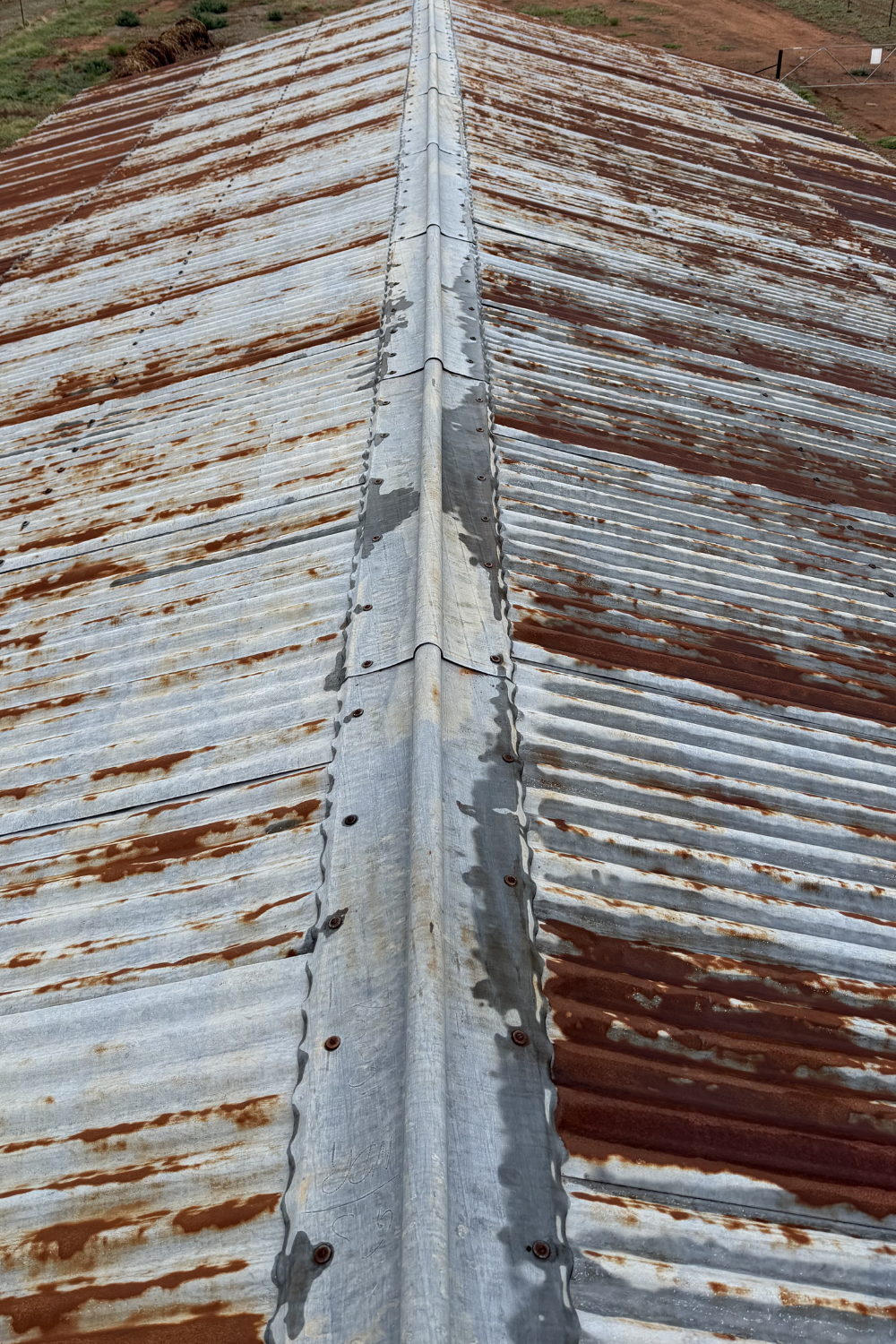 A rusty metal roof in Bluff prior to painting.