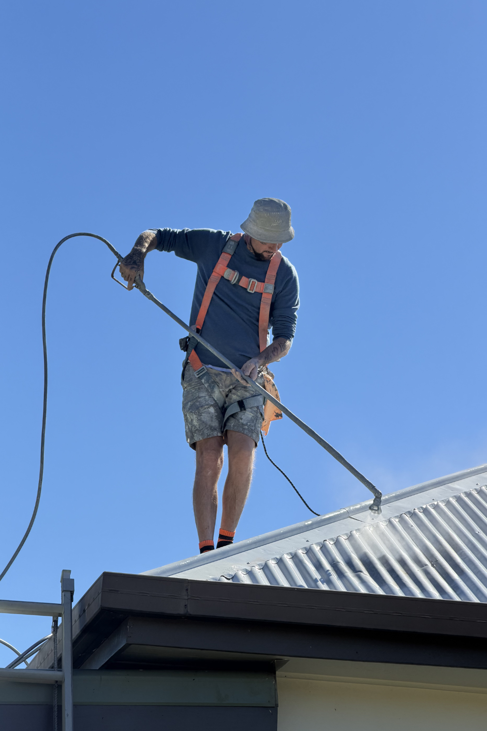 Alfie Hendry of Hendry’s Restorations. painting a roof in Queensland.
