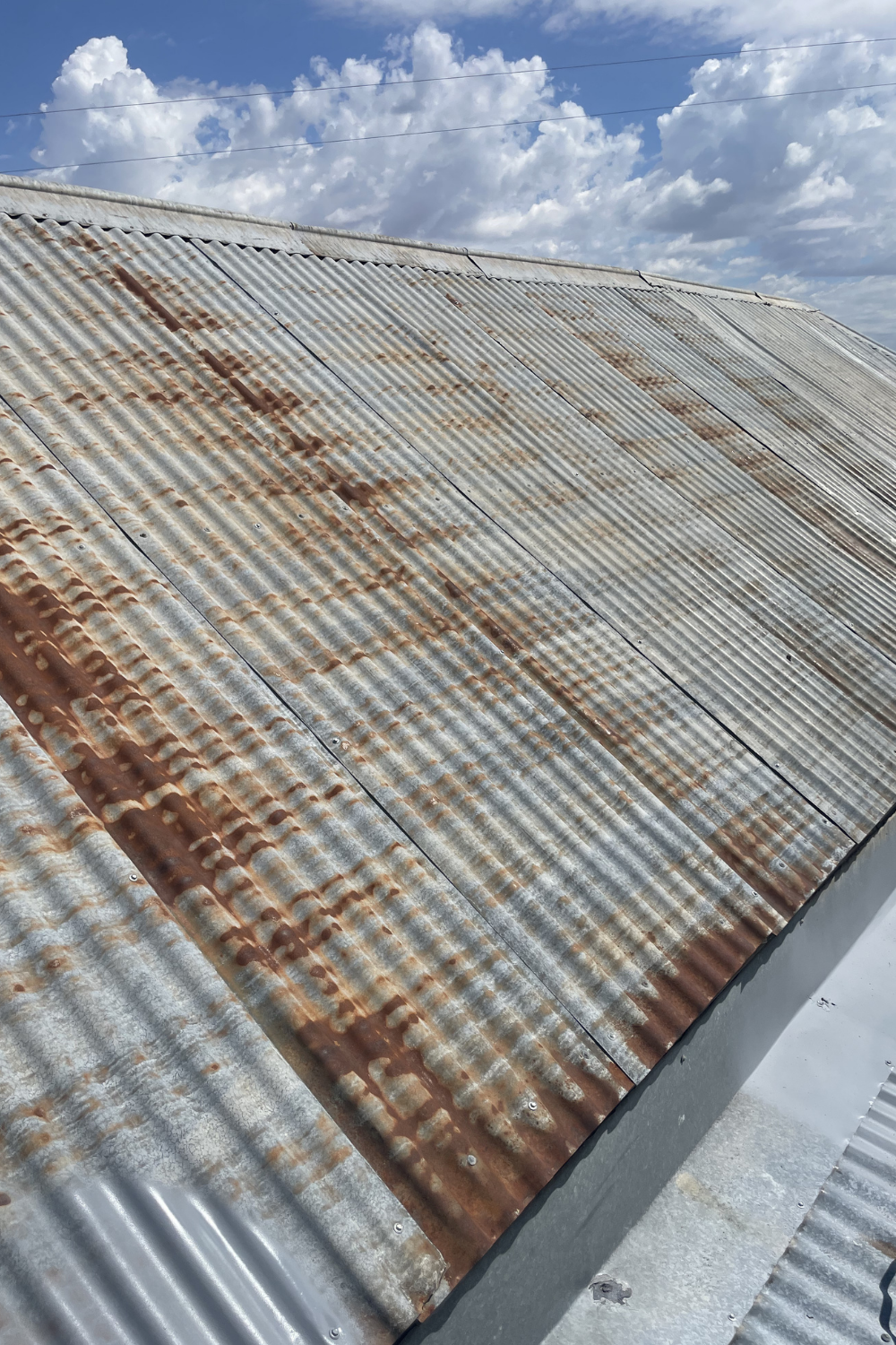 A rusty metal roof in Roma prior to painting.