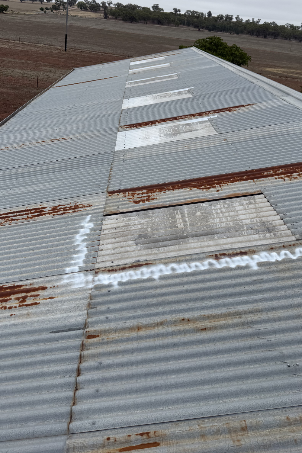 A rusty metal roof in Banana prior to painting.