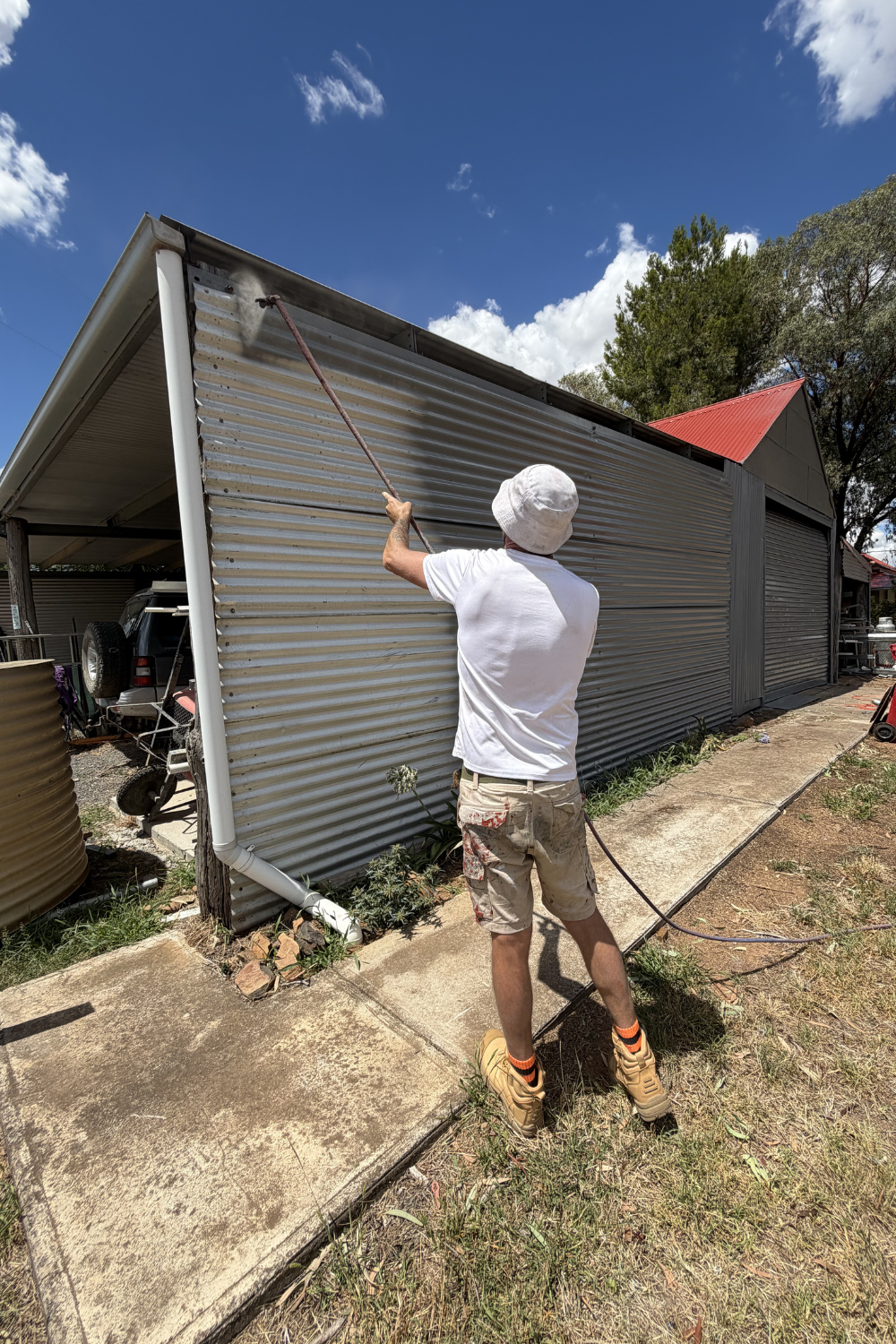 Alfie Hendry of Hendry’s Restorations painting a shed.