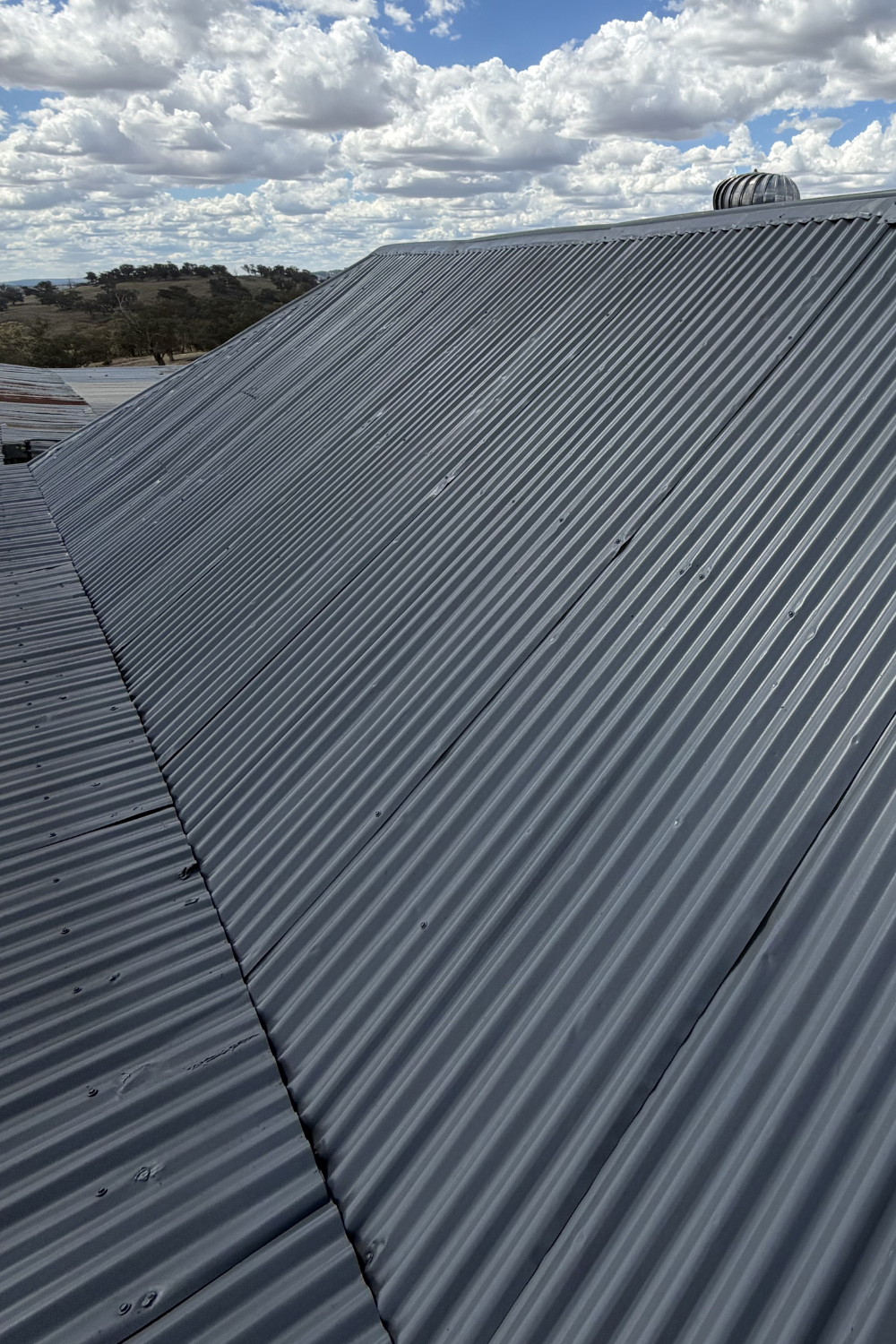 A freshly painted metal roof in Mitchell after painting grey.