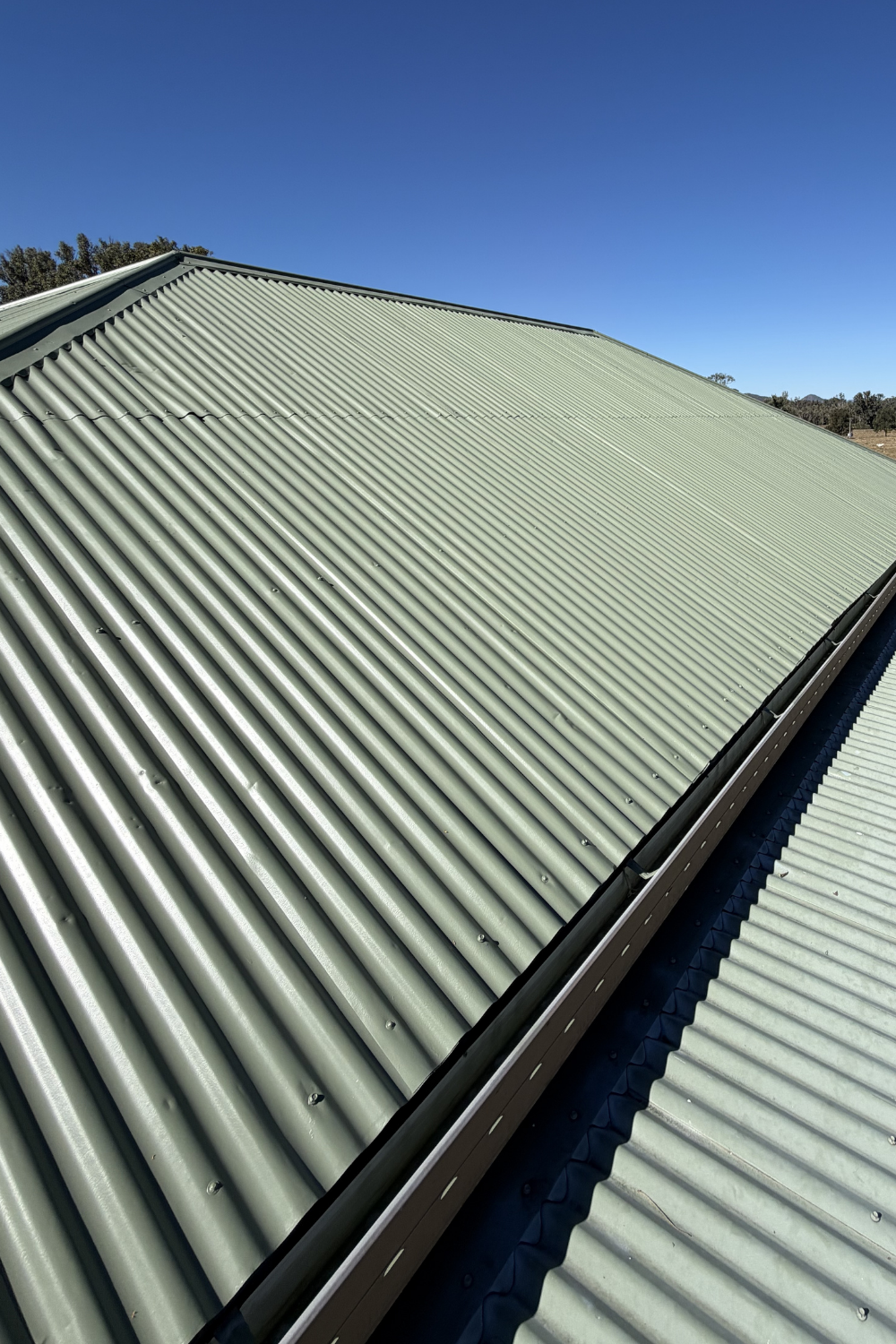 A freshly painted metal roof in Surat after painting green.