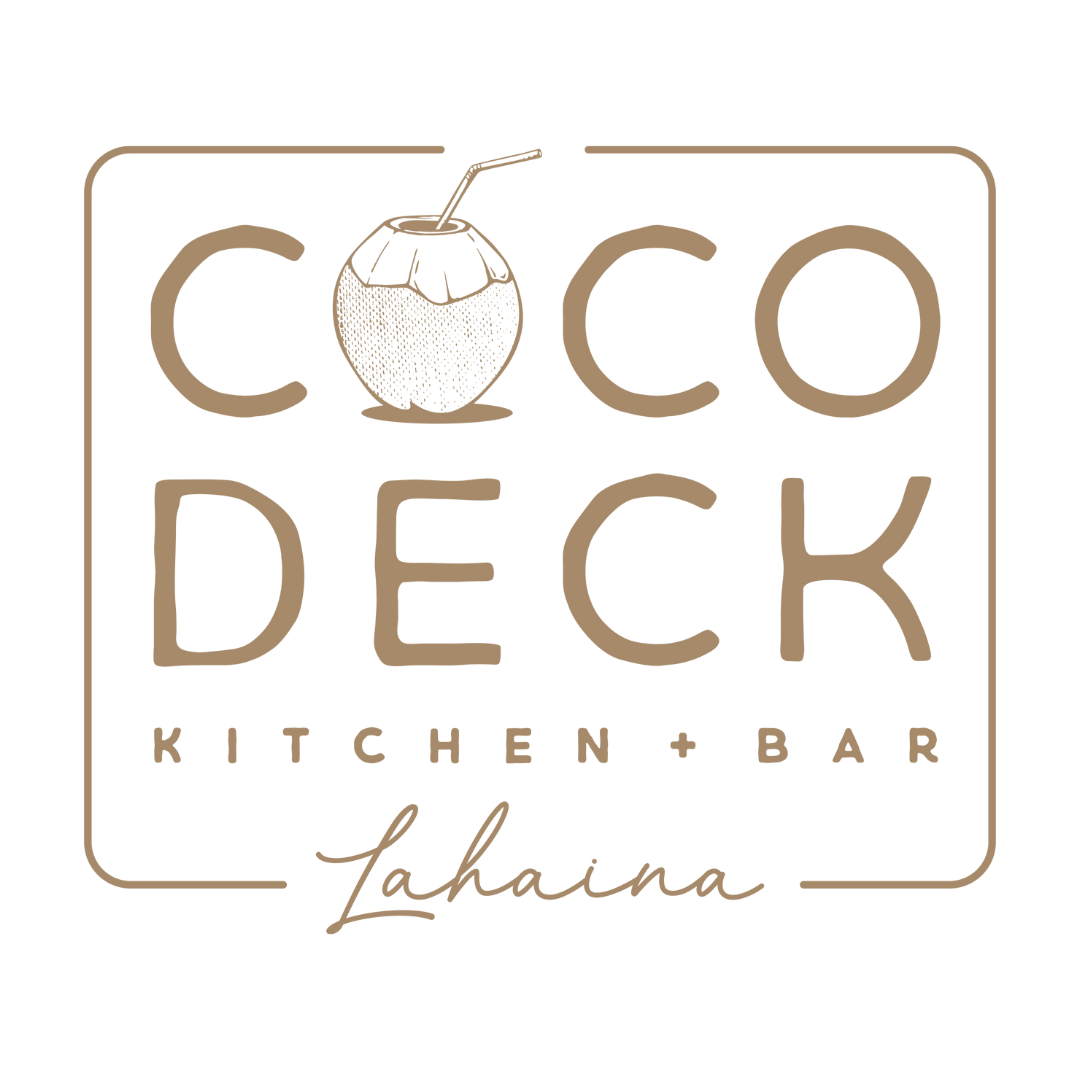 Outdoor sign for Coco Deck Kitchen + Bar at sunset with umbrellas and ocean in background.
