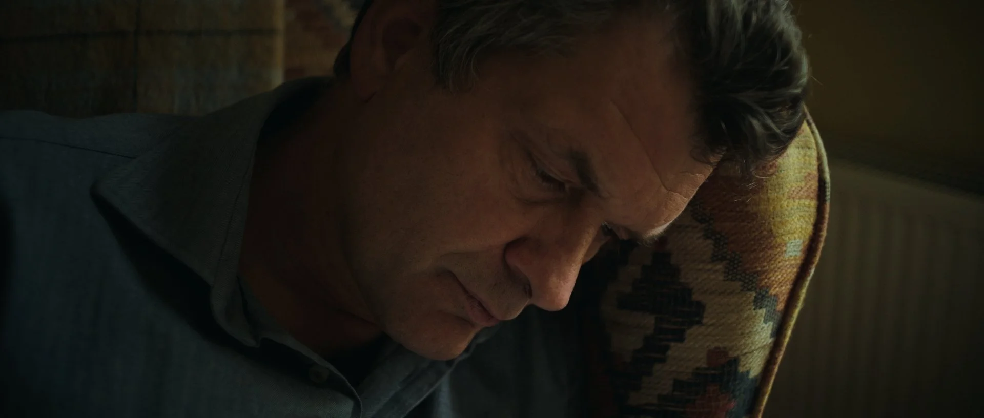 Extreme close-up of Jan-Jacob reading, the soft light wrapping his almost silhouetted face