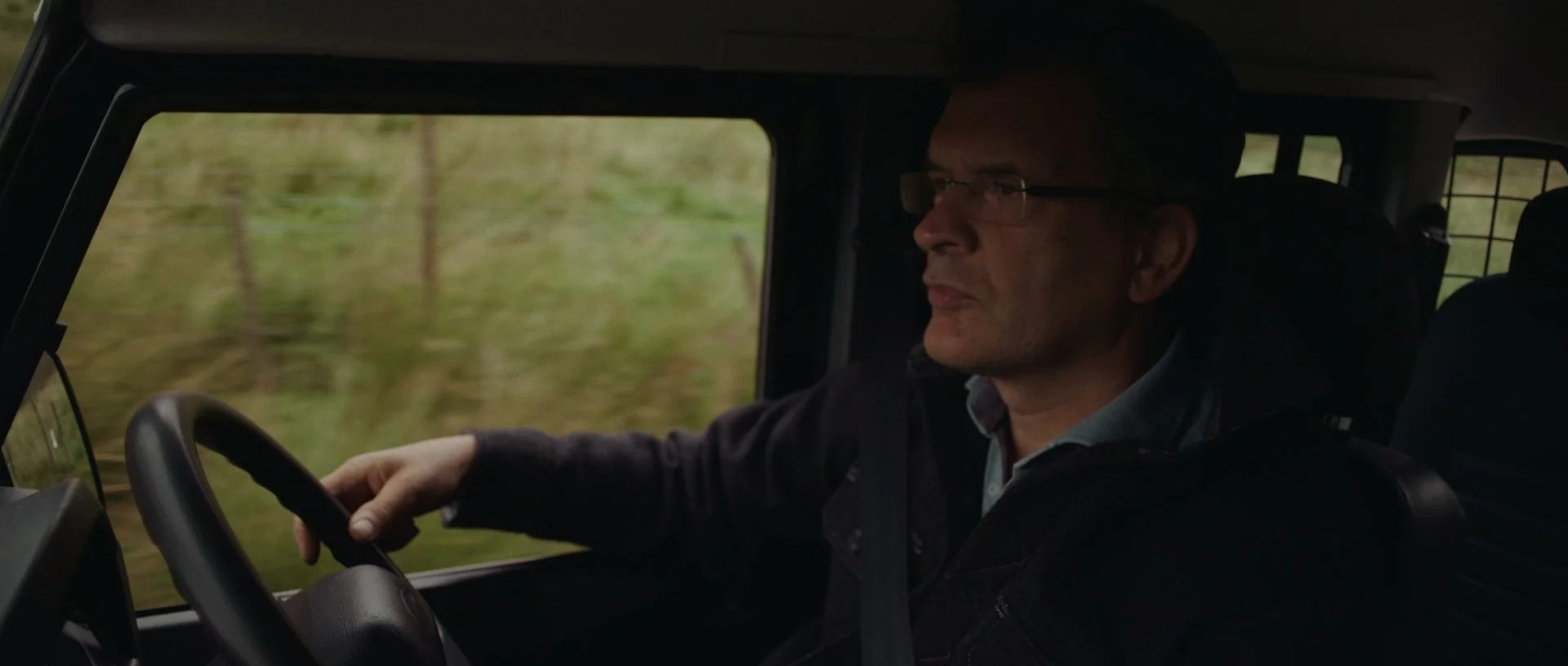 Interior shot of Jan Jacob driving his Land Rover through the staggering Glen Roy