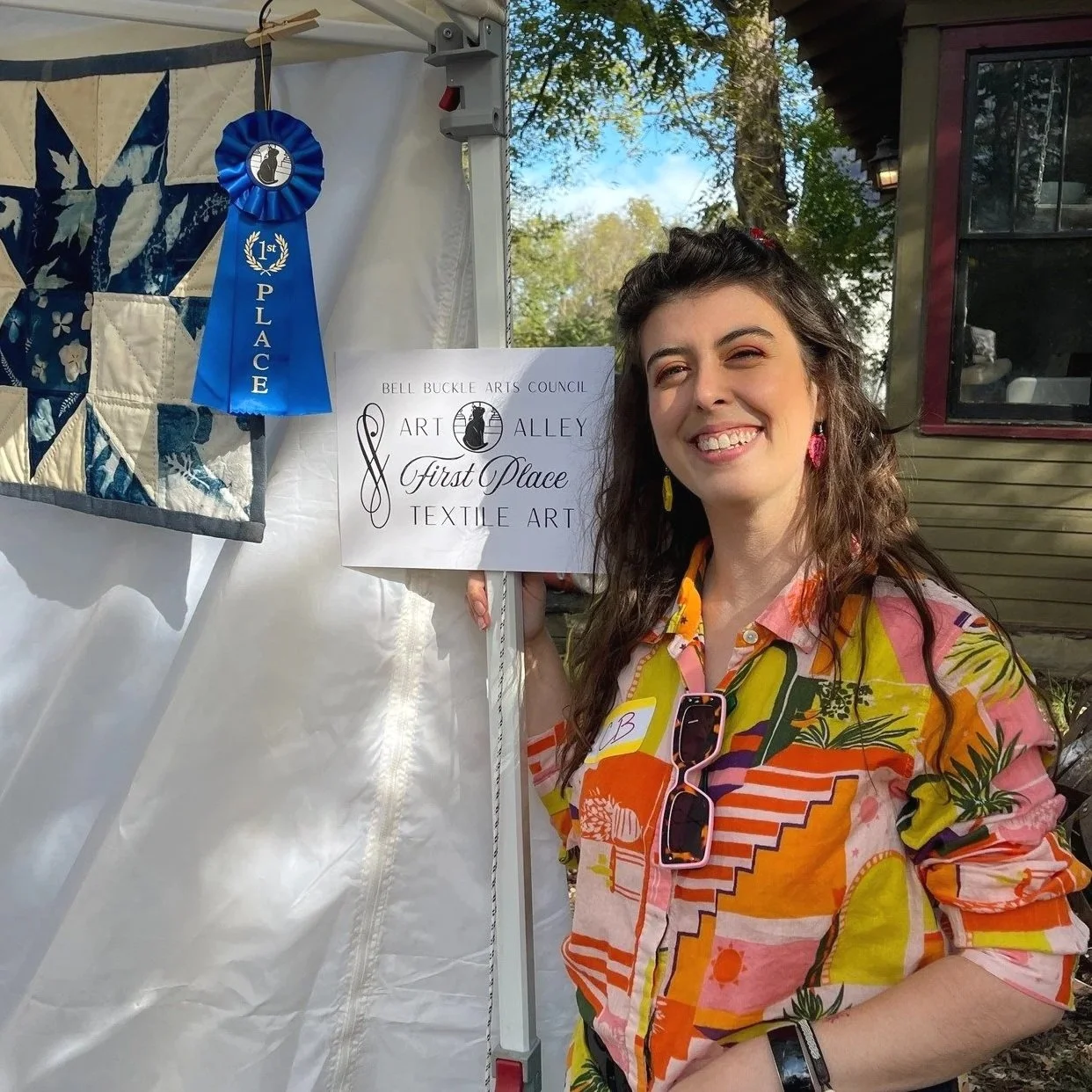 Collage with a woman in an orange dress, a blue botanical print, a quilt with white floral patterns, and colorful fabric eye masks.