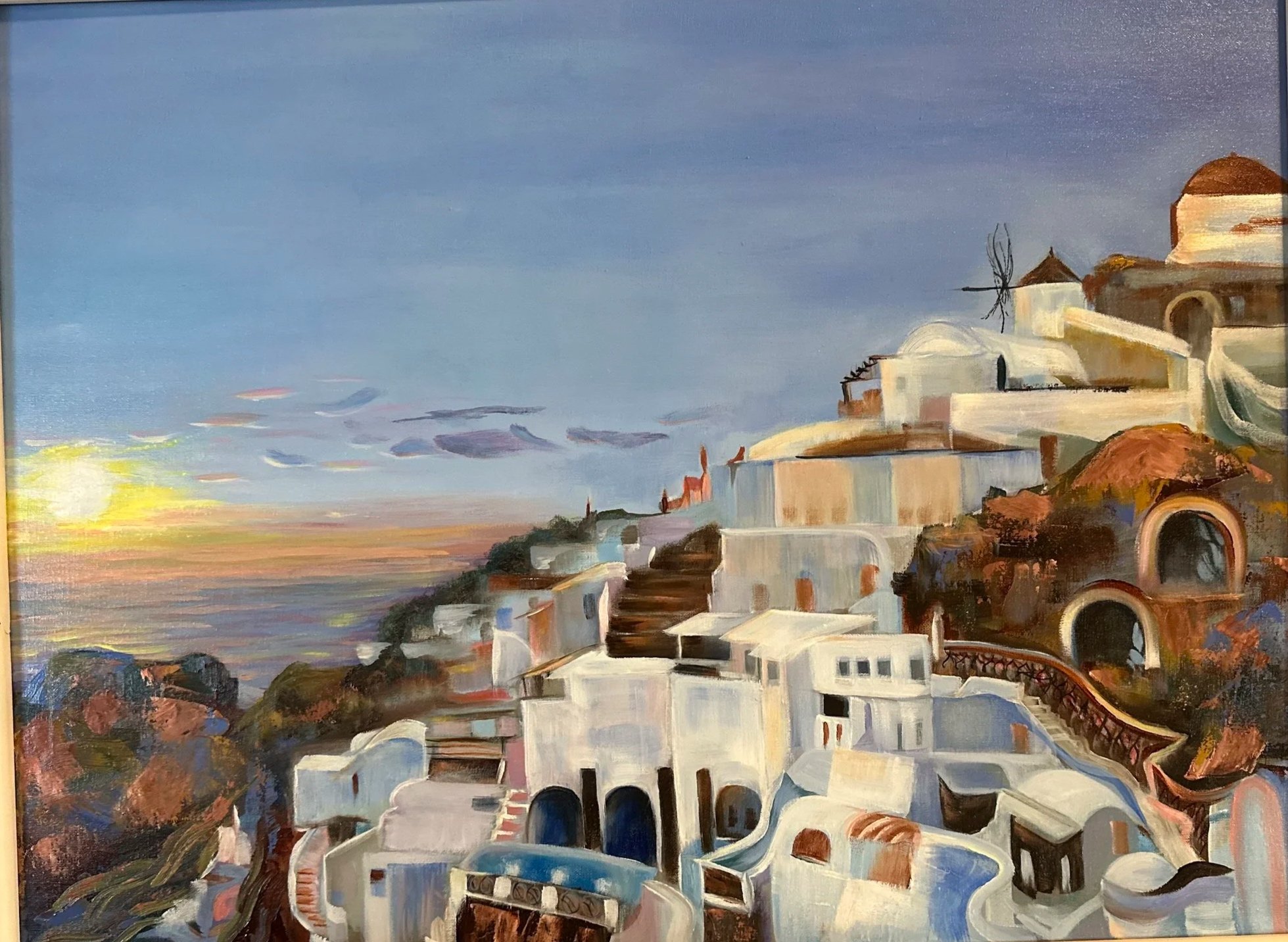 Painting of a hillside town at sunset, with white buildings and a blue sky featuring some clouds.