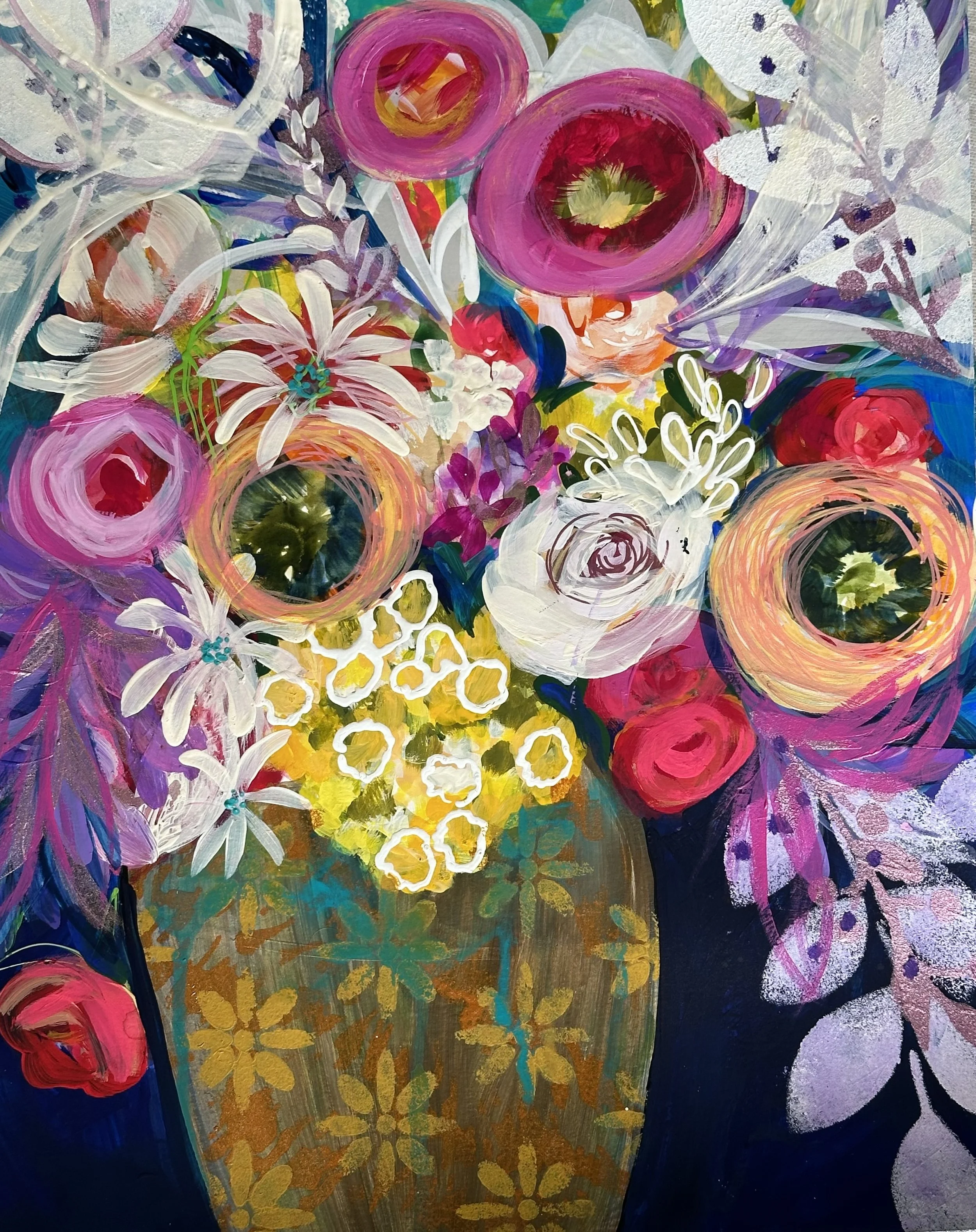 Close-up of an abstract painting featuring bright pink, white, purple, blue, green, and yellow colors with floral shapes and patterns