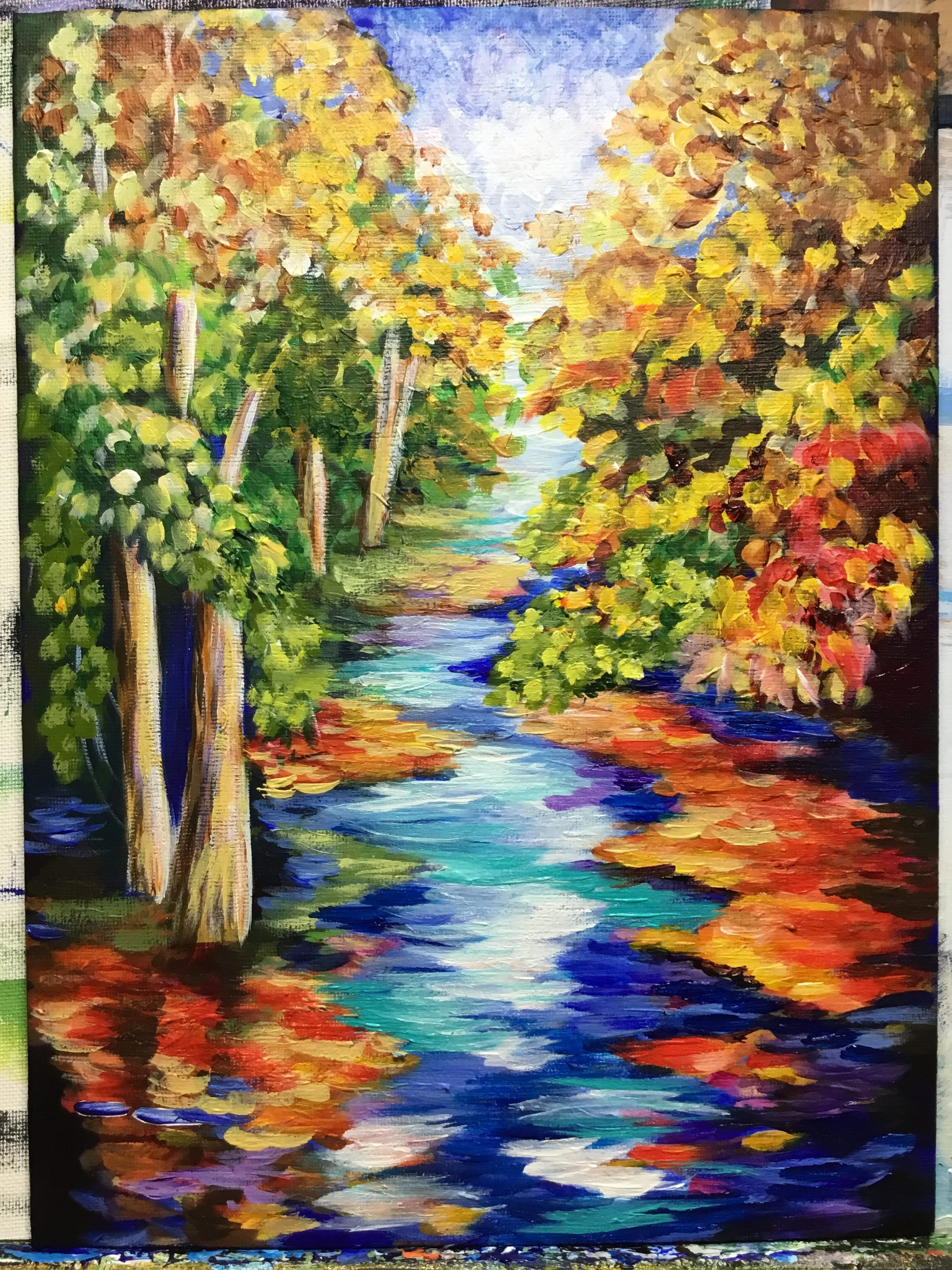 A colorful painting of a riverside scene with trees on both sides and reflections on the water, created with bold, expressive brushstrokes in warm and cool tones.
