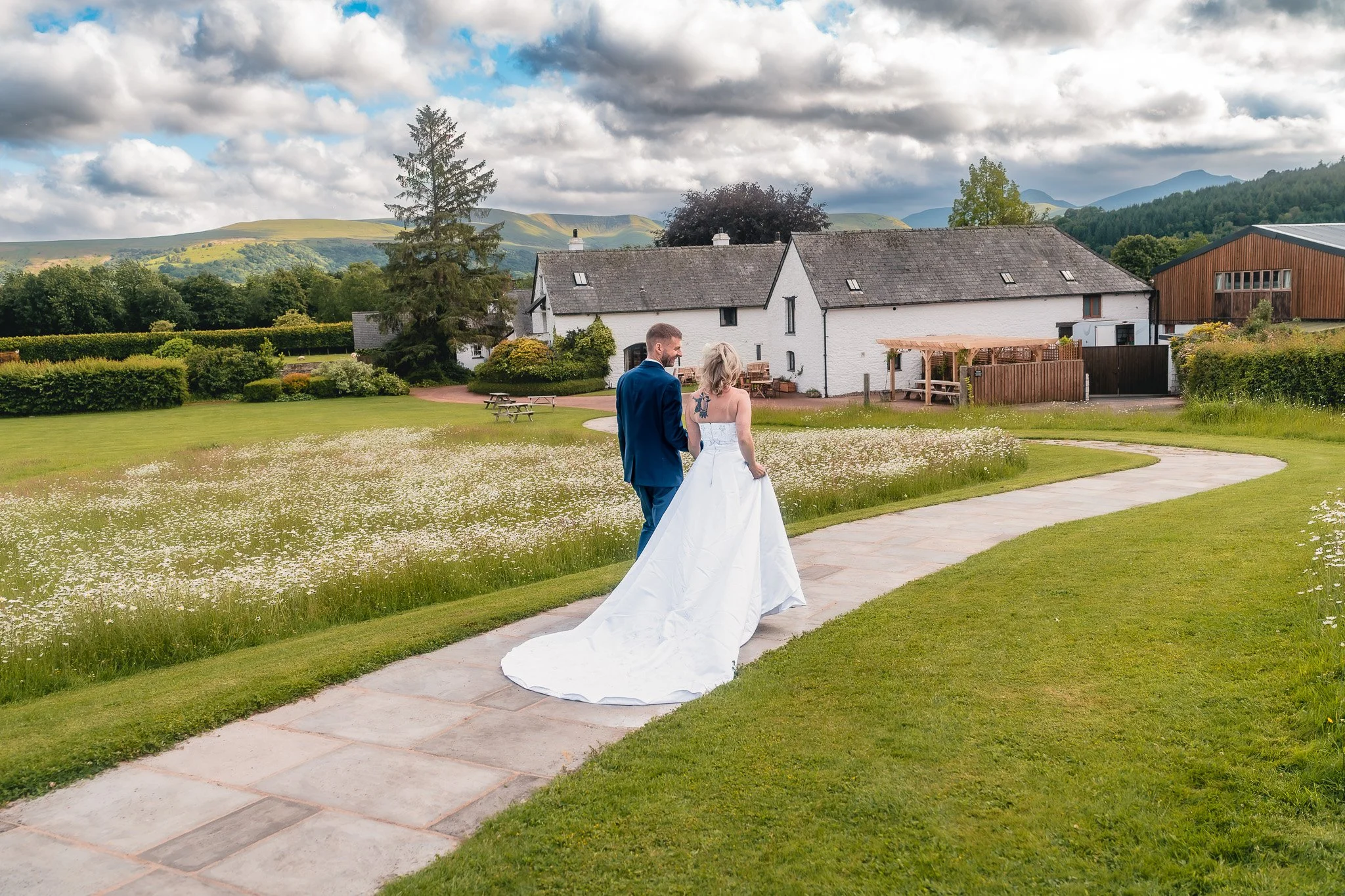 Bride and groom walking together at Barn at Brynich