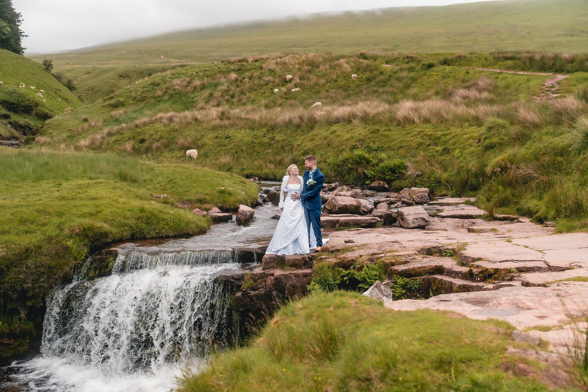 Relaxed wedding portraits by a Welsh waterfall